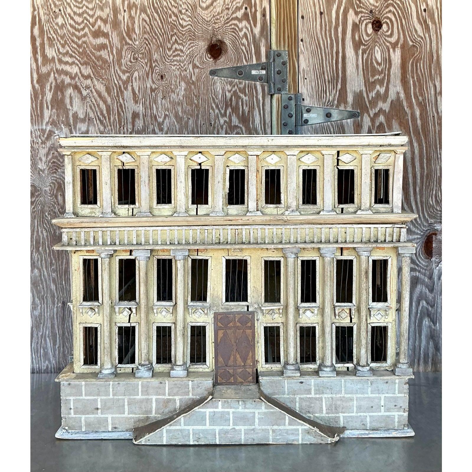 Ce modèle architectural vintage exquis est une pièce captivante de l'artisanat, présentant des colonnes classiques complexes, des découpes de fenêtres détaillées et une finition magnifiquement vieillie. Avec sa façade néoclassique grandiose, ce
