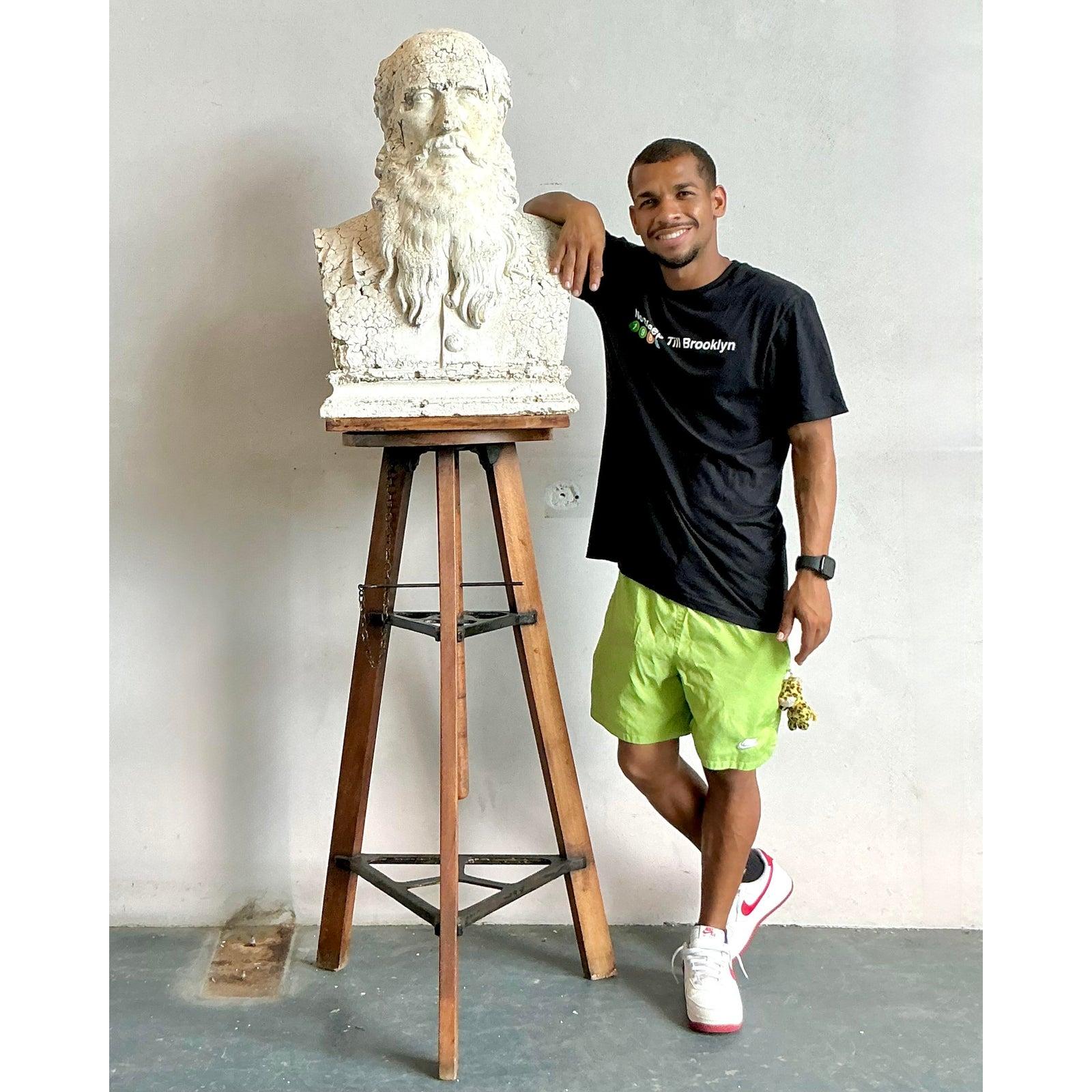 Embrace the artful imperfection of this captivating vintage plaster bust, a remarkable piece that infuses any space with a sense of historical gravitas and bohemian charm. Depicting a distinguished bearded man, likely a philosopher or artist, the