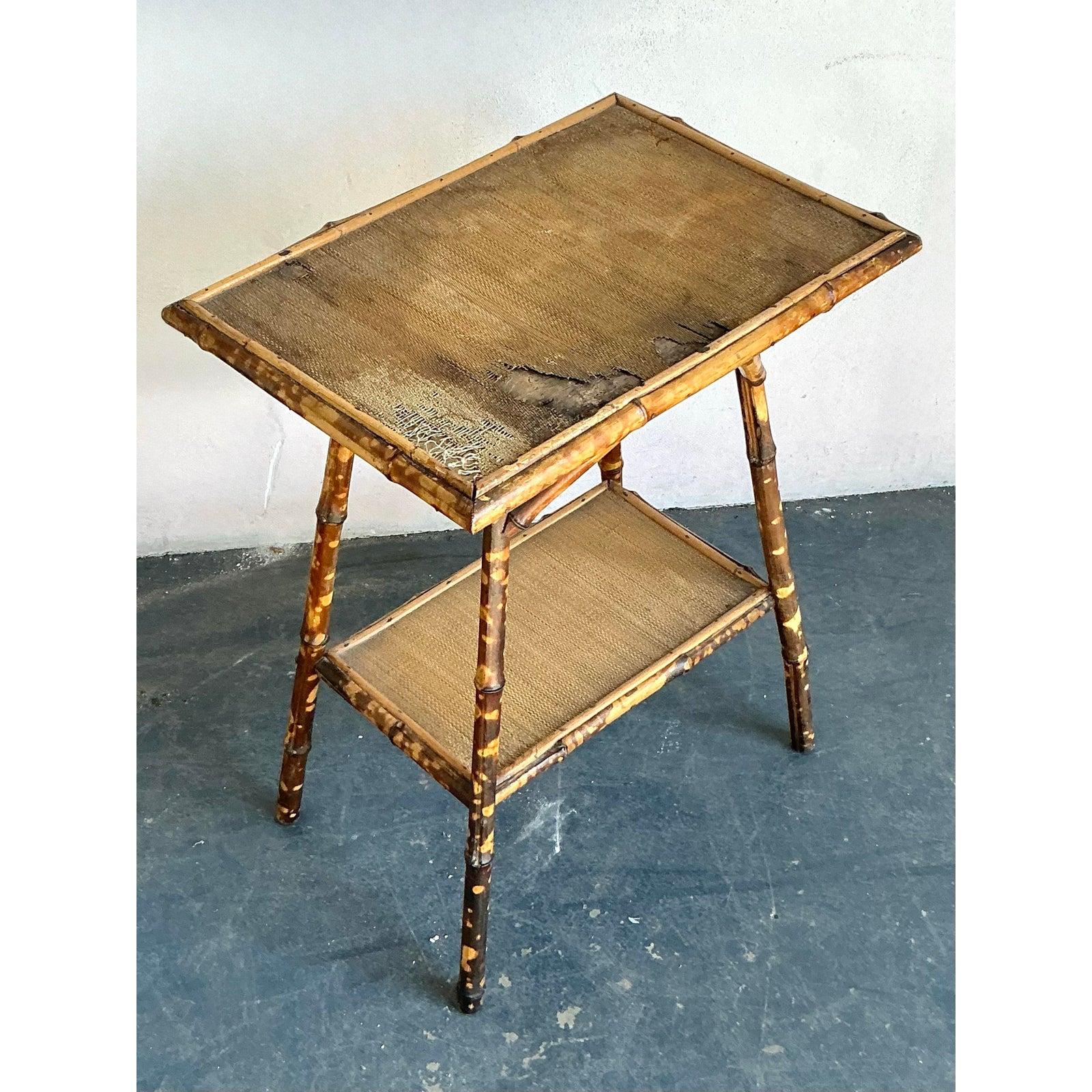 Infuse your home with a touch of exotic, laid-back elegance with this vintage Boho Chic side table, crafted from distressed tortoise bamboo and rattan. This unique piece embodies the relaxed luxury of 1970s design, featuring a charmingly aged bamboo