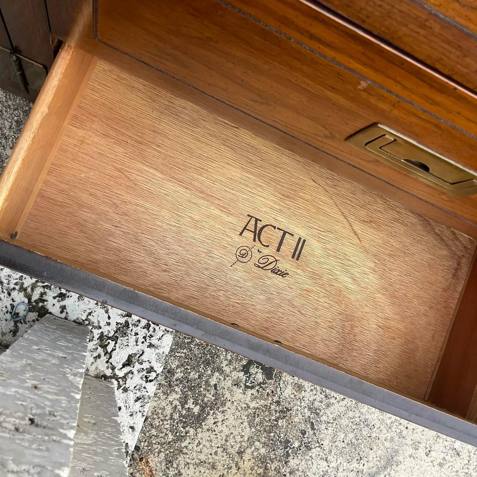 A fabulous vintage Boho Campaign credenza. Made by the iconic Dixie group and is part of their “Act II” collection. Rich wood and burnished brass hardware make this a great addition to any room. Acquired from a Palm Beach estate. 