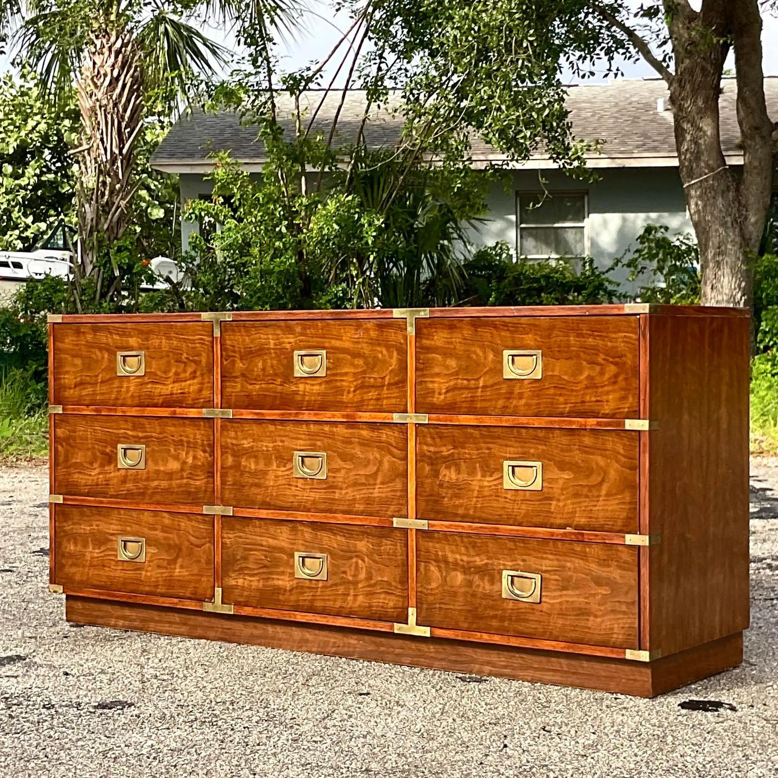 A fabulous vintage Boho Campaign dresser. Made by the iconic Drexel group. Beautiful wood grain detail and burnished brass hardware. Signed inside the drawer. Acquired from a Palm Beach estate.
