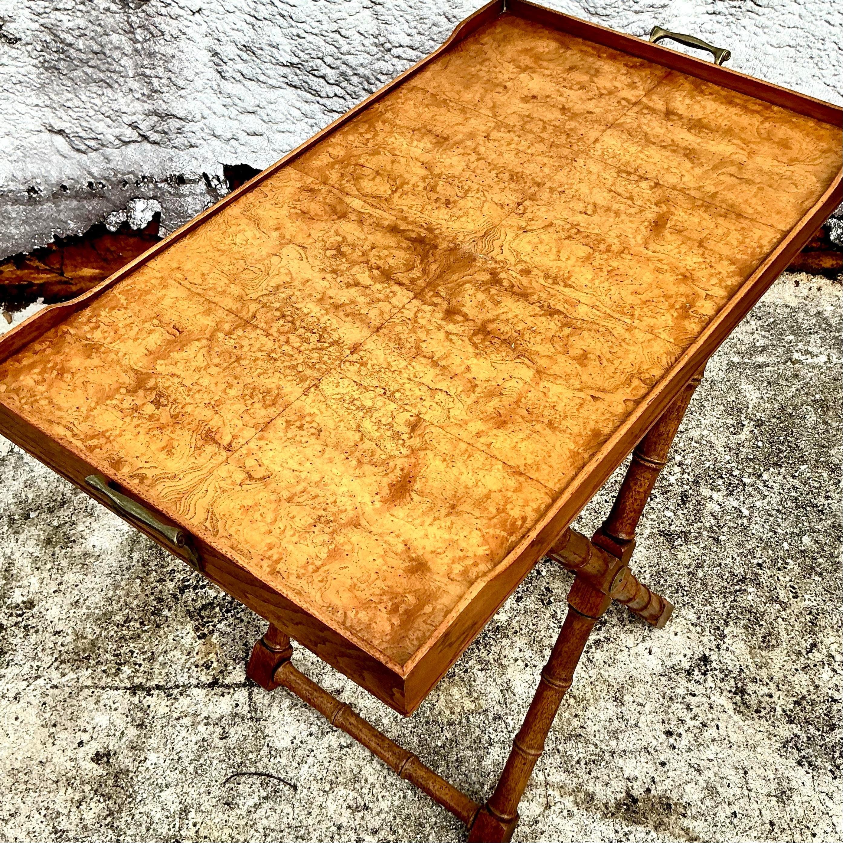 Add a touch of vintage sophistication to your home with this Vintage Boho Drexel Heritage Burlwood Tray Table. Crafted from luxurious burlwood, the table's rich, intricate grain patterns create a visually stunning surface that exudes warmth and