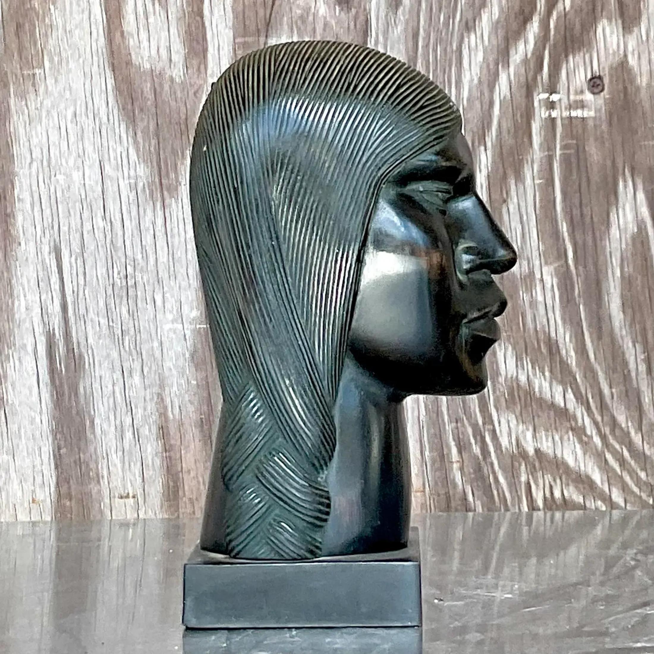 A fabulous vintage Boho carved ebony wood sculpture. A chic bust of man with stylized braids. Acquired from a Palm Beach estate.
