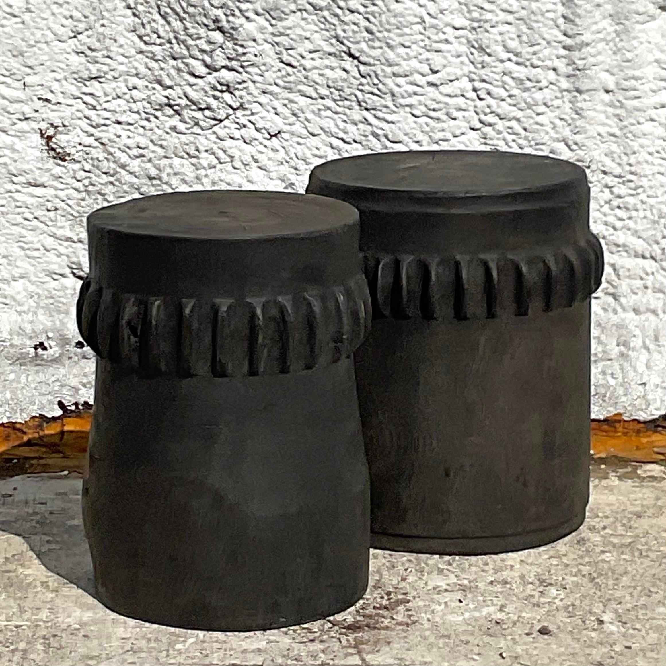 Add a touch of rustic Americana to your home with this pair of vintage boho ebony paddle stump low stools. Crafted with natural charm and authenticity, these stools bring the essence of the great outdoors into your living space. Their rugged yet