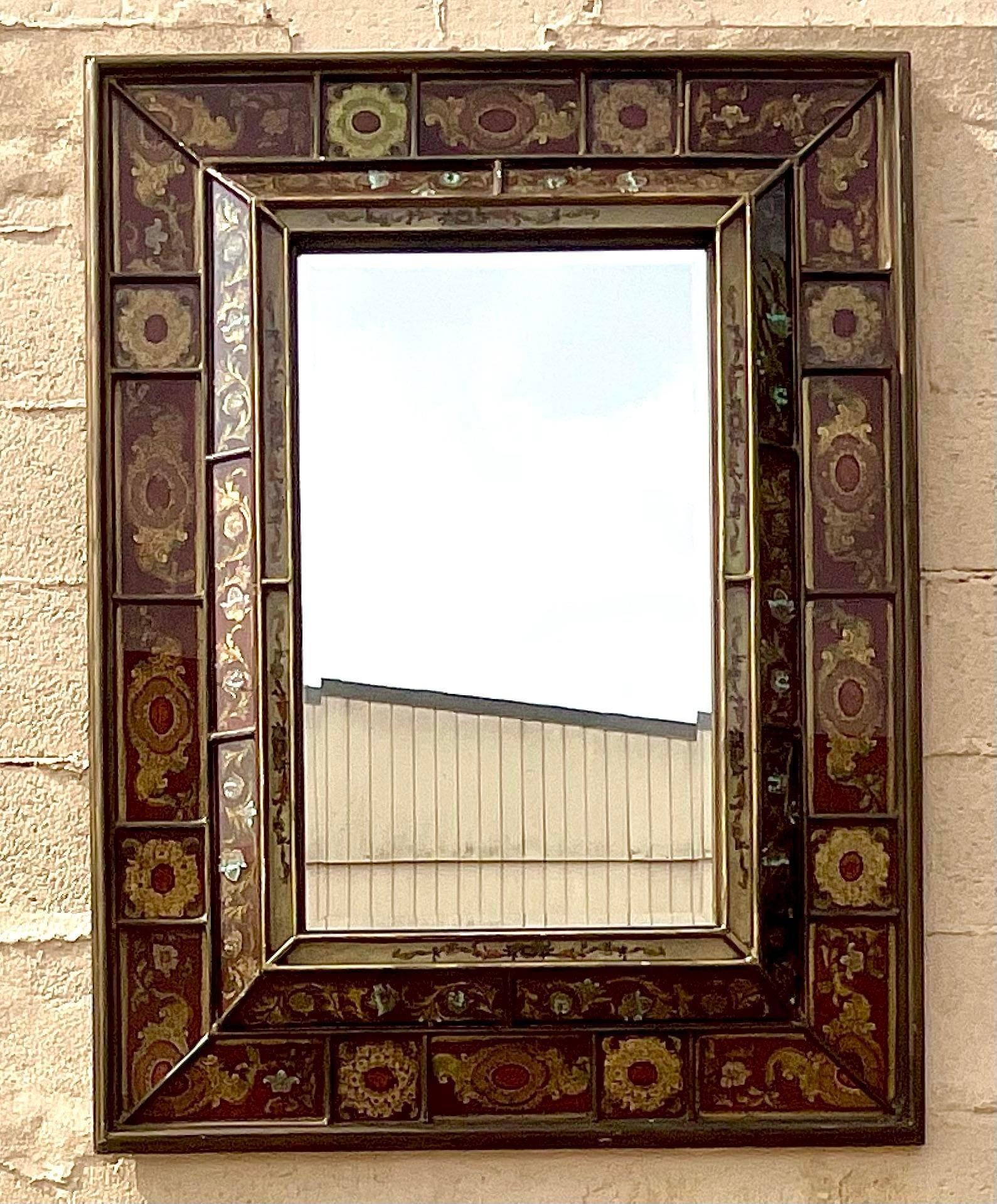 Add a touch of vintage charm with our Vintage Boho Eglomise Mirror. This exquisite piece features eglomise glass with intricate detailing, blending Bohemian flair with classic American style. A timeless mirror that adds elegance and character to any