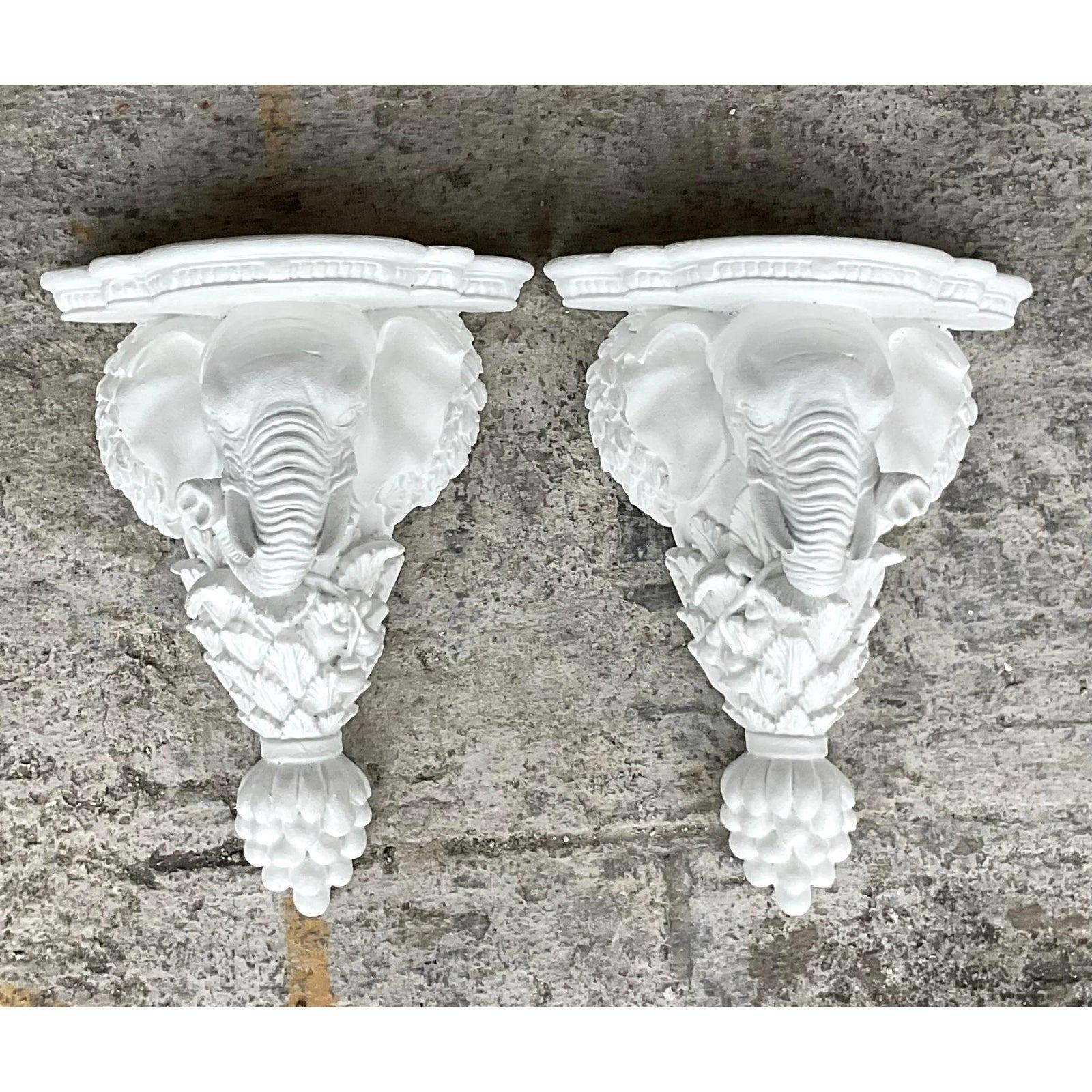 A fabulous pair of vintage Boho brackets. A chic pair of handsome elephants in a bright white finish. Perfect indoors or outside in a covered area. Acquired from a Palm Beach estate.