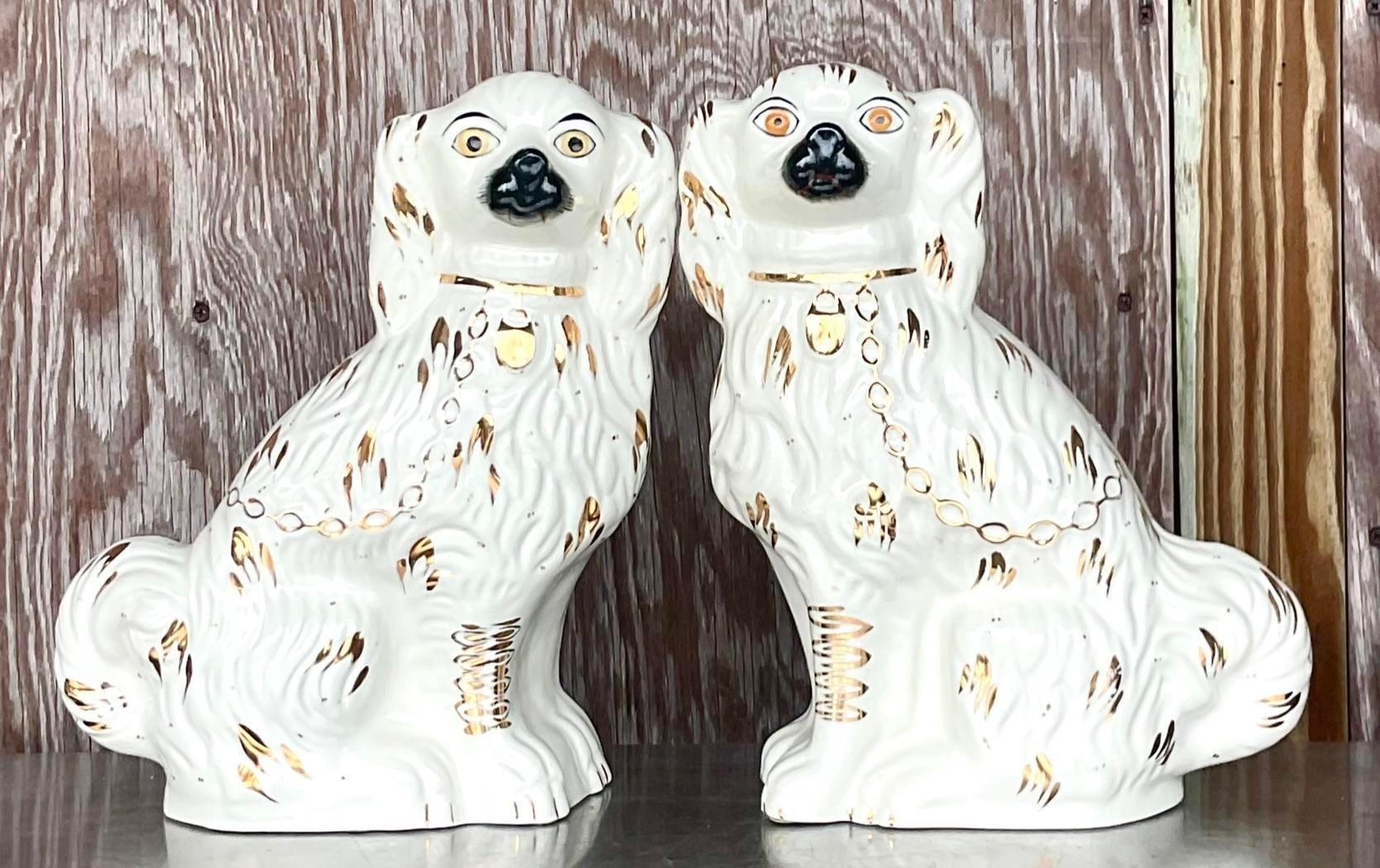 A fabulous pair of glazed ceramic dogs. Made by the Staffordshire group in Kent, England. Beautiful hand painted detail and signed on the bottom. Acquired from a Palm Beach estate.