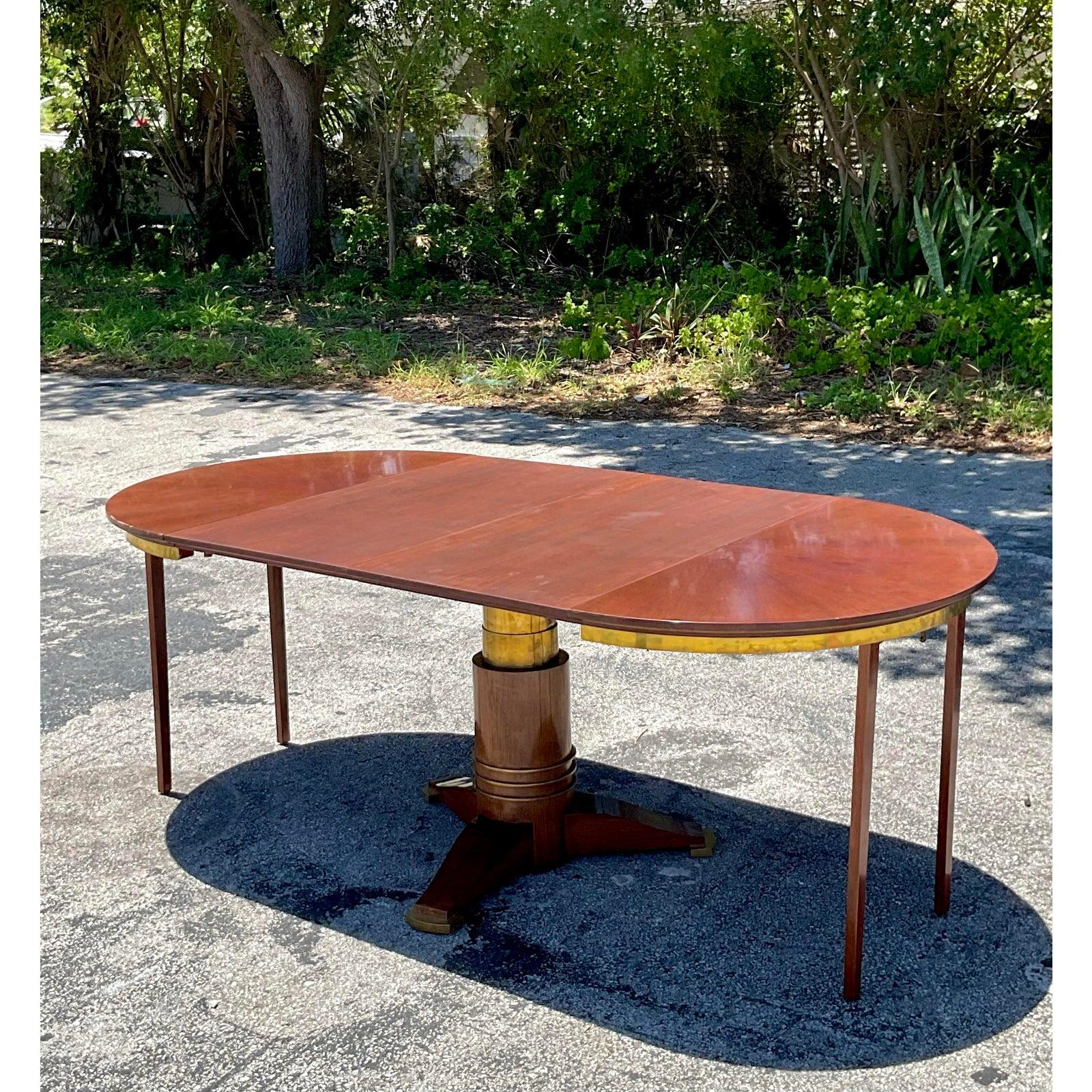 Embrace timeless elegance with this vintage round dining table, featuring a smart expandable design perfect for both intimate dinners and larger gatherings. The table showcases a rich, warm wood finish on its circular top, which is elegantly