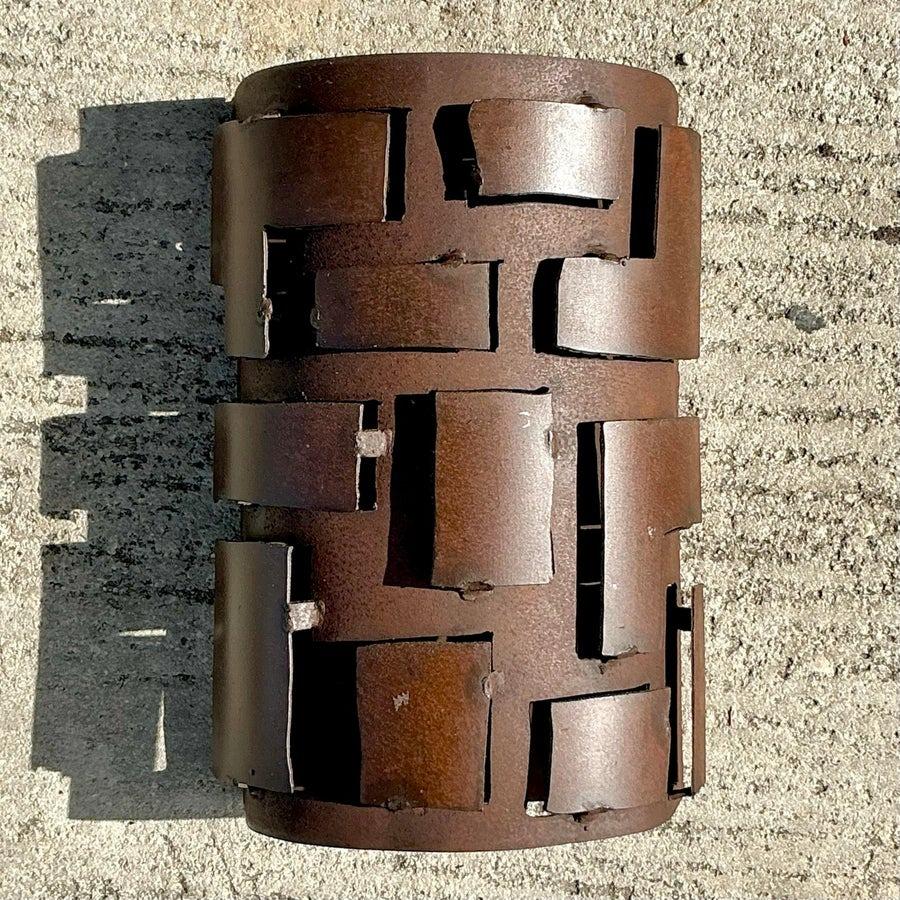 Enhance your decor with the bold elegance of this vintage boho French Brutalist wall sconce cover. Featuring a striking, hand-forged metal design with textured detailing, this piece reflects the rugged sophistication of Brutalist artistry. Its
