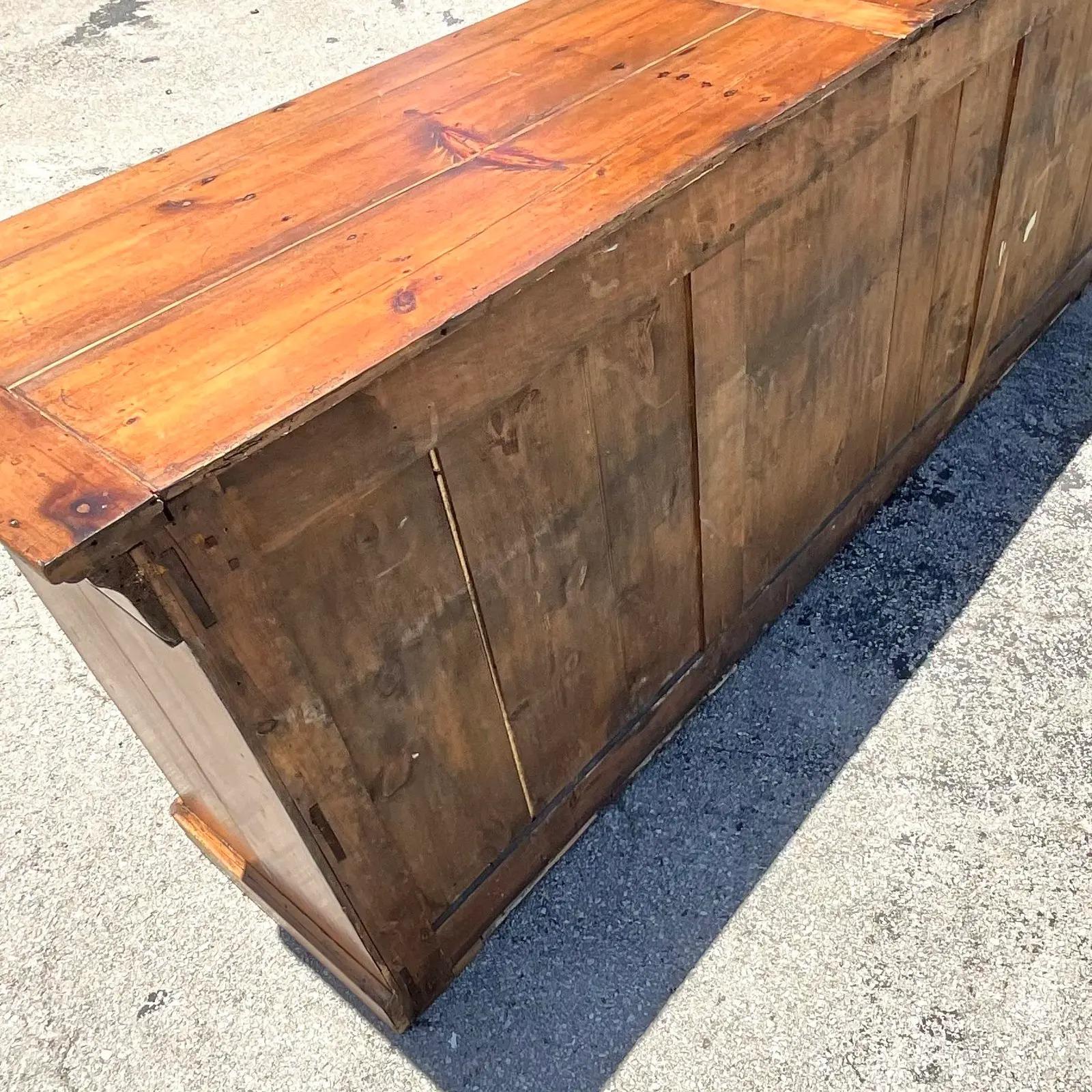 Fantastic authentic French credenza. Beautiful weathers pine with the gorgeous patina of time. Beautiful wood grain detail. Lots of great storage below. Acquired from a Boca estate.