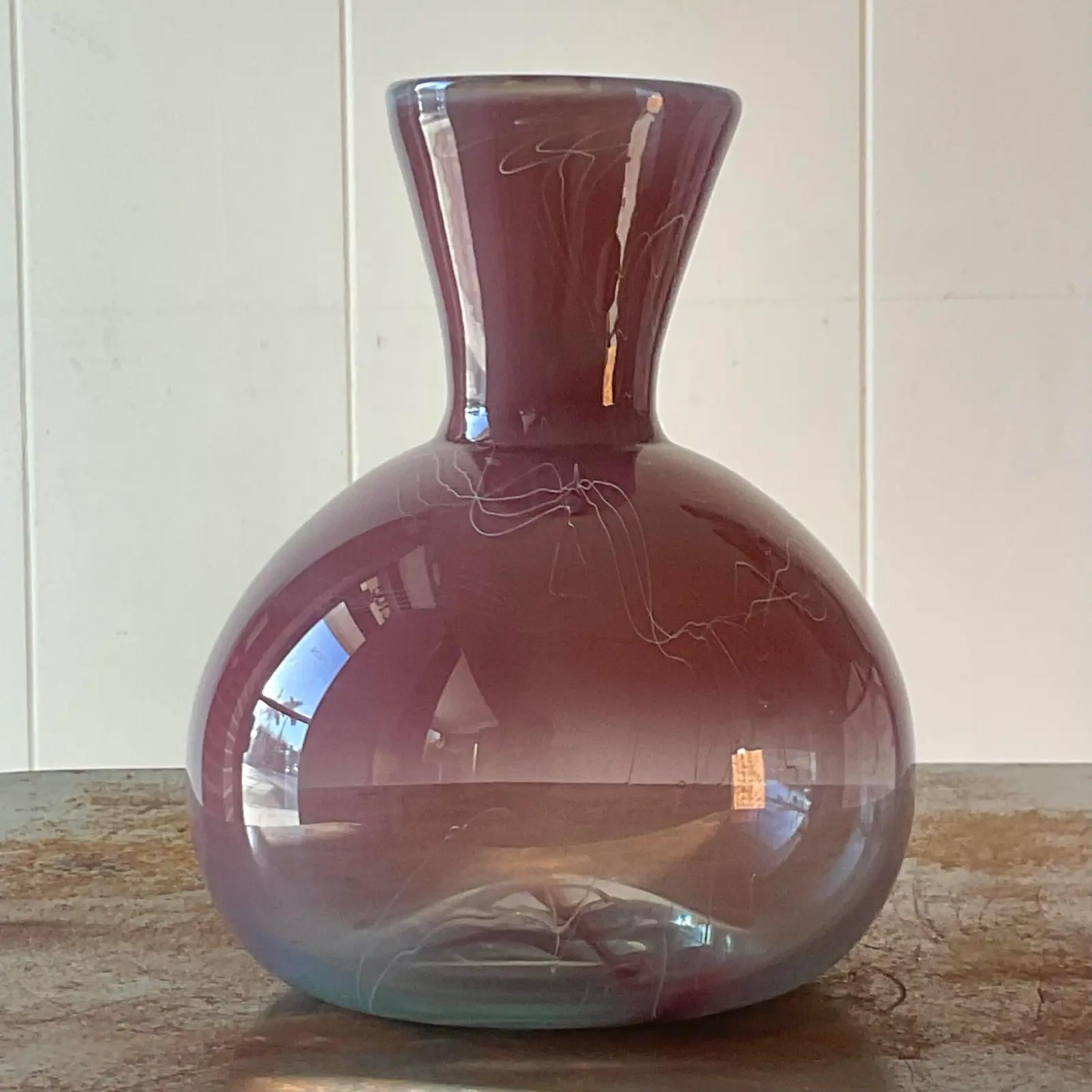 A stunning vintage Boho glass vase. A chic Radiant rose colored glass with a fused squiggle on top. Signed on the bottom. Acquired from a Palm Beach estate