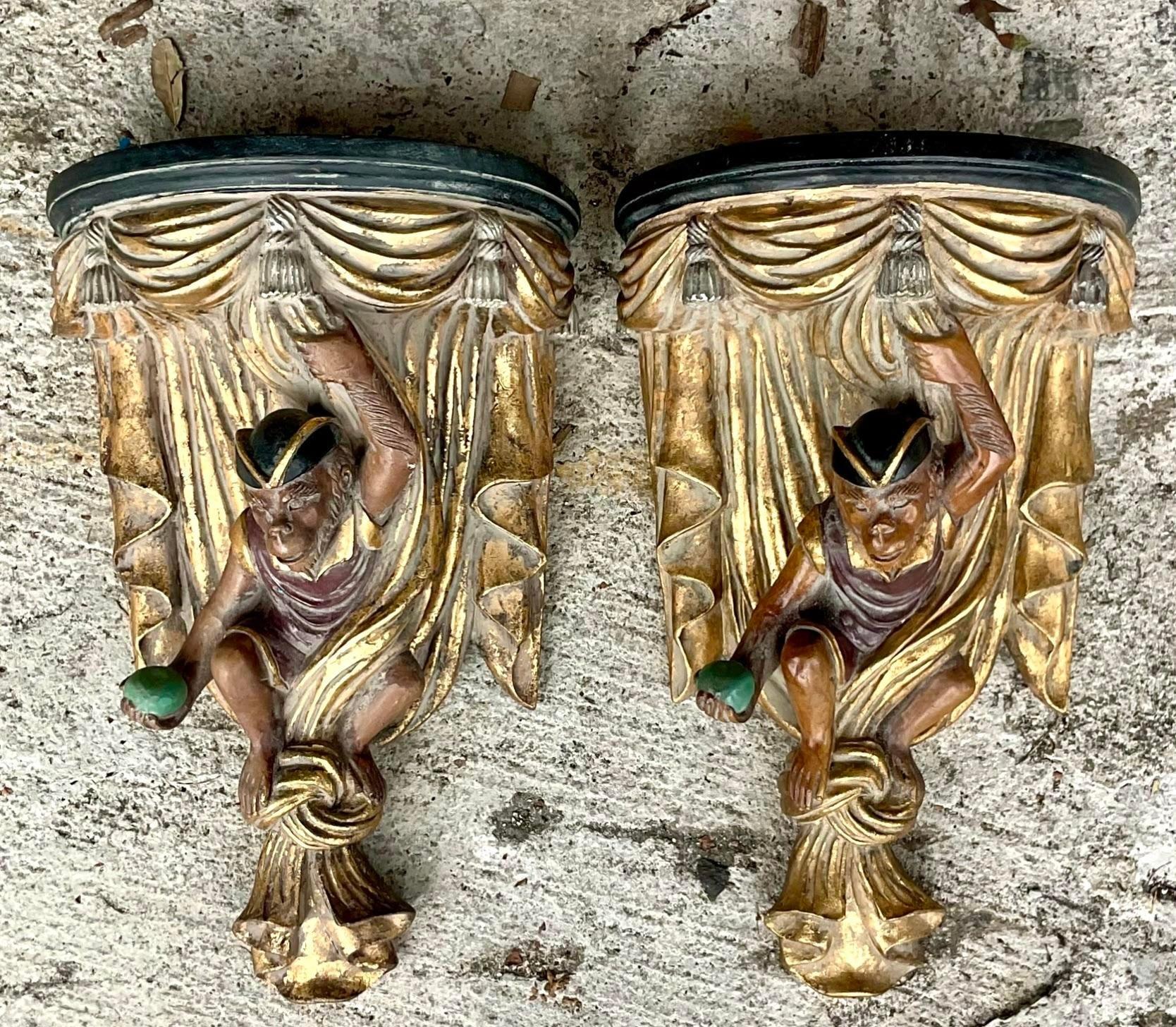 A stunning pair of vintage Boho wall brackets. A chic pair of wood composite swag monkeys with gorgeous gilt tipping. Acquired from a Palm Beach estate.