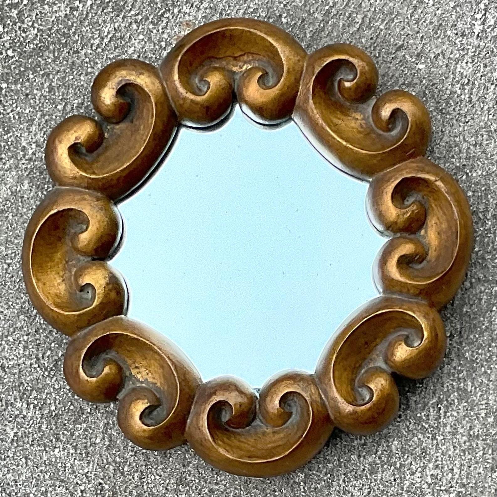 A fabulous vintage Boho wall mirror. A thick gilt frame with charming swirl detail. Acquired from a Palm Beach estate.