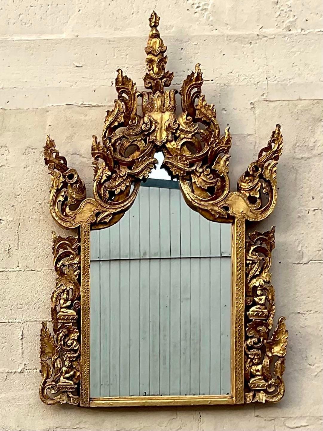A fabulous vintage Boho wall mirror. A chic Temple design in a bright gilt finish. Hand carved detail with mirrored pin dots along the flourish. A real showstopper. Acquired from a Palm Beach estate.