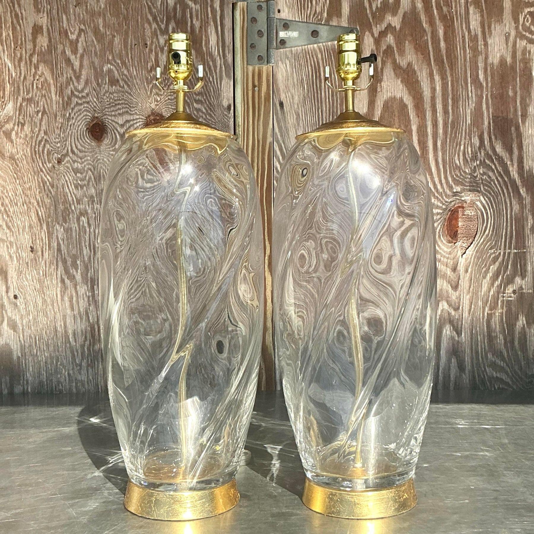 Add a touch of vintage elegance to your decor with this pair of vintage boho glass swirl lamps. Featuring stunning glass bases with intricate swirl detailing, these lamps exude timeless charm and artisanal sophistication. Their translucent design