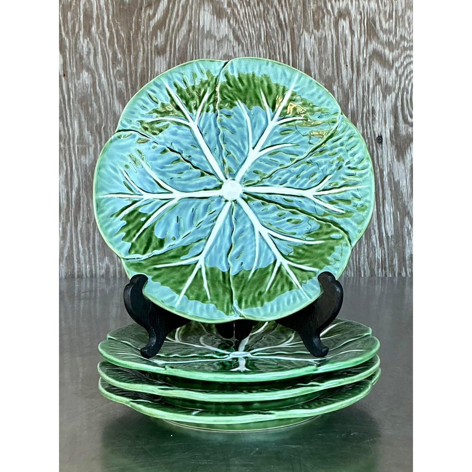 Bring a touch of nature-inspired charm and whimsical style to your table or decor with this set of four glazed ceramic plates, designed in the classic and beloved cabbage leaf motif. Each plate is beautifully molded and finished with a vibrant green