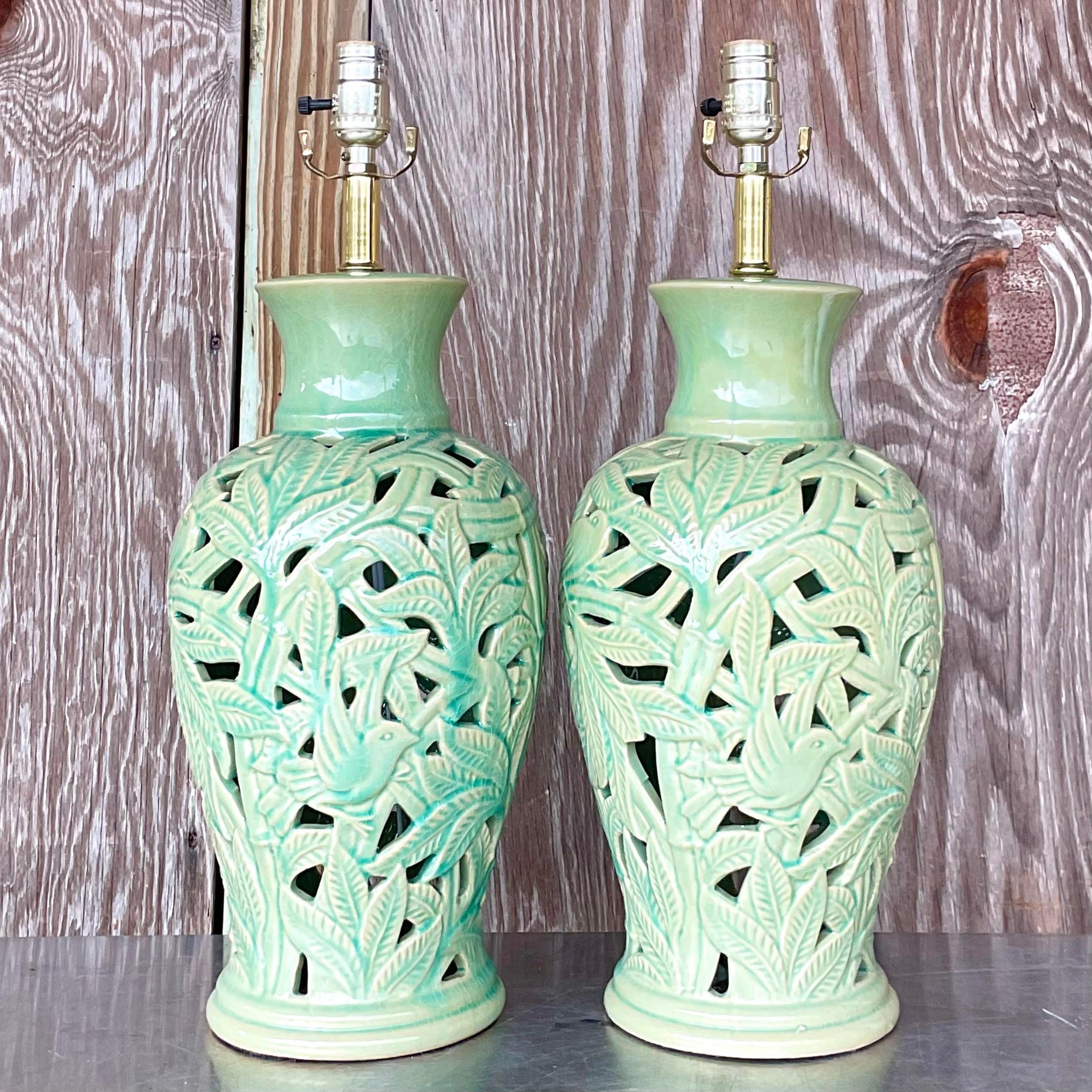 A stunning pair of vintage Boho table lamps. A gorgeous green glazed camera body with a chic cut out leaf design. Acquired from a Palm Beach estate.