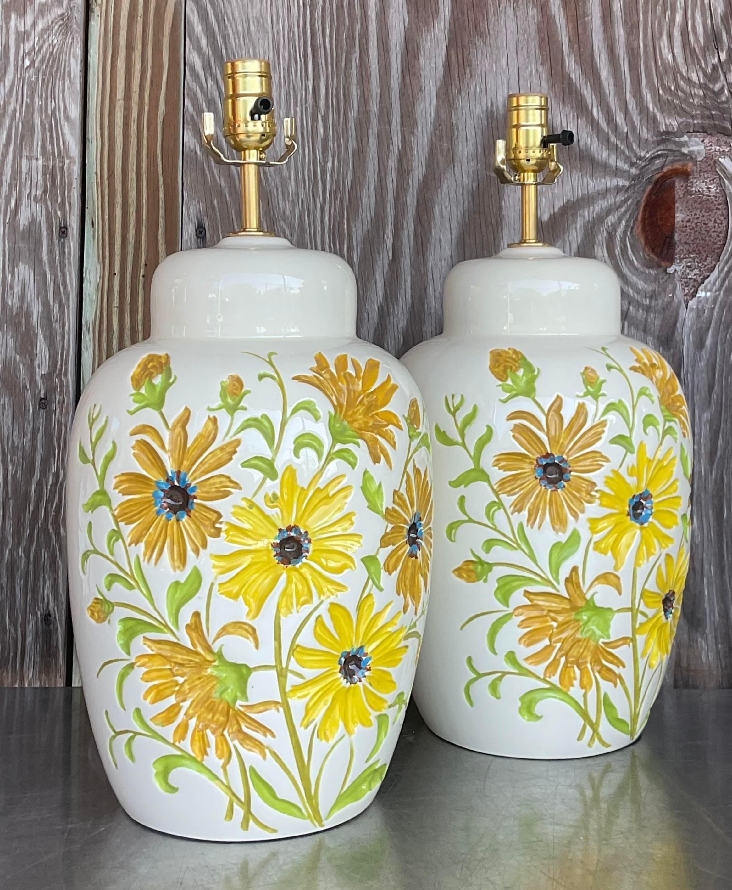 Illuminate your space with the whimsical charm of our Pair of Vintage Boho Glazed Ceramic Daisy Lamps, a delightful fusion of American craftsmanship and bohemian flair. Adorned with dainty daisy motifs, these lamps exude nostalgic charm while