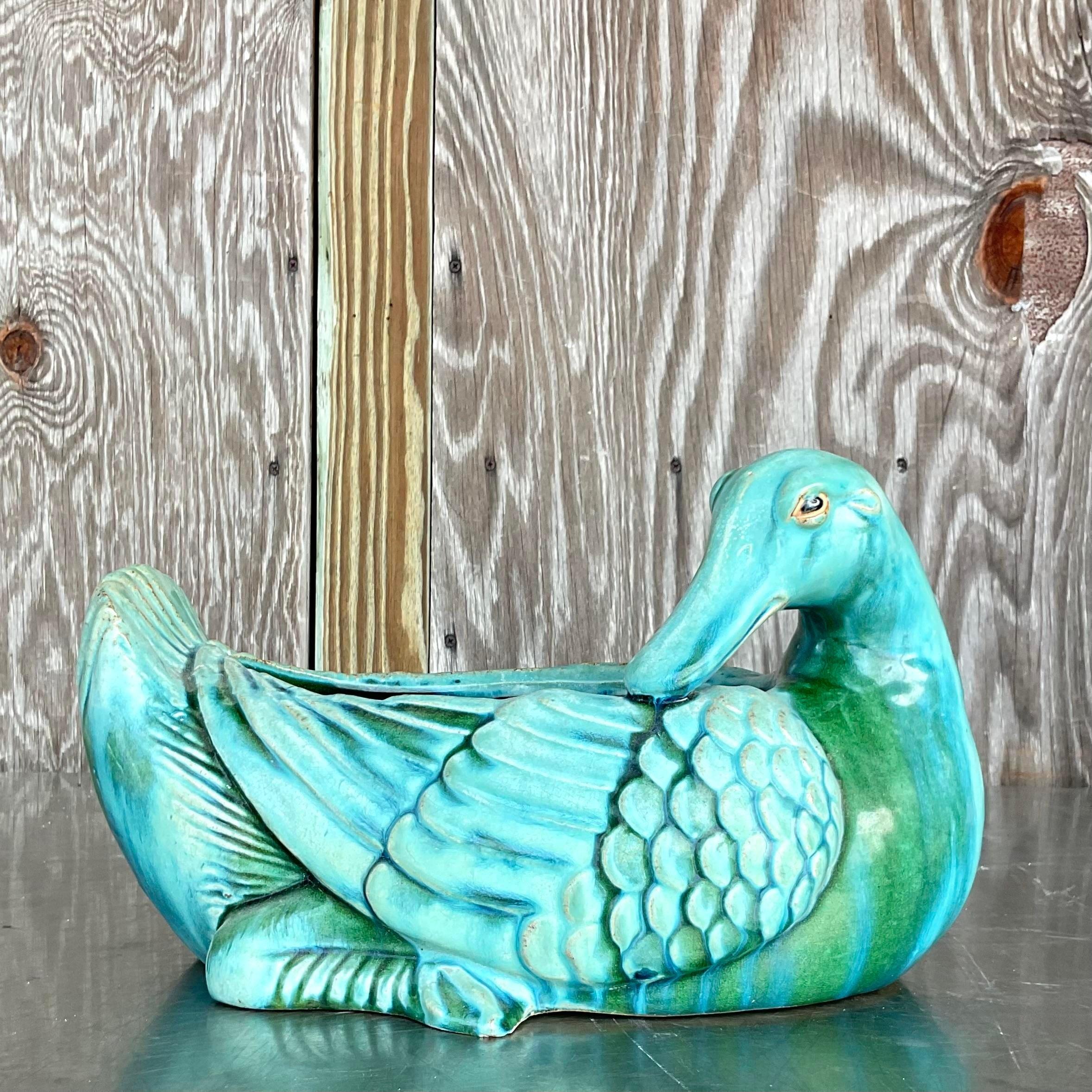 Add a touch of whimsy and character to your space with this delightful vintage ceramic duck planter. With its bohemian flair and glossy glazed finish, this charming piece brings a playful yet sophisticated vibe to any room. Perfect for eclectic