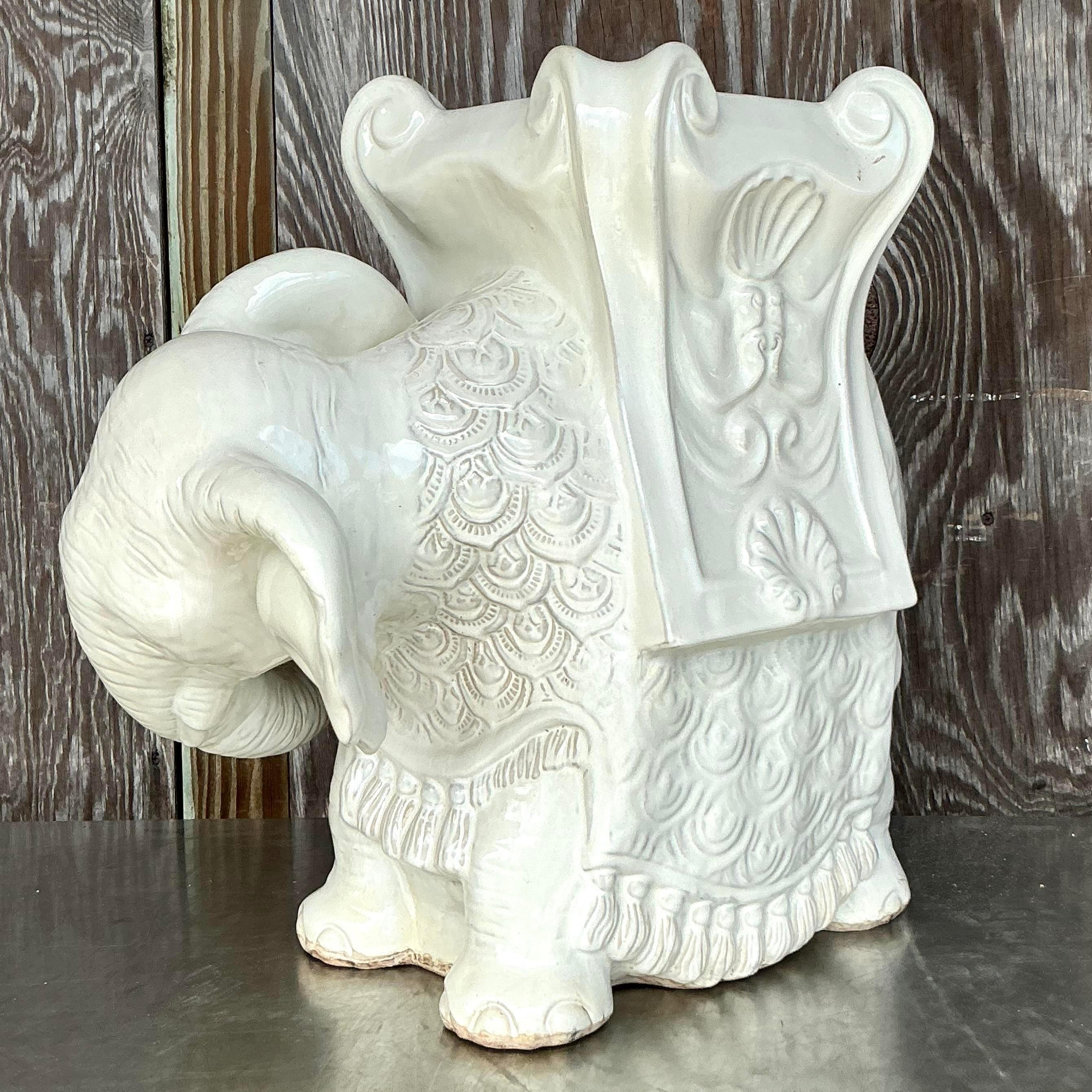 Introduce a touch of exotic boho elegance to your home with this charming vintage glazed ceramic elephant stool. Crafted with intricate detailing, this piece features a stunning glossy finish that highlights its ornate patterns and lifelike form.