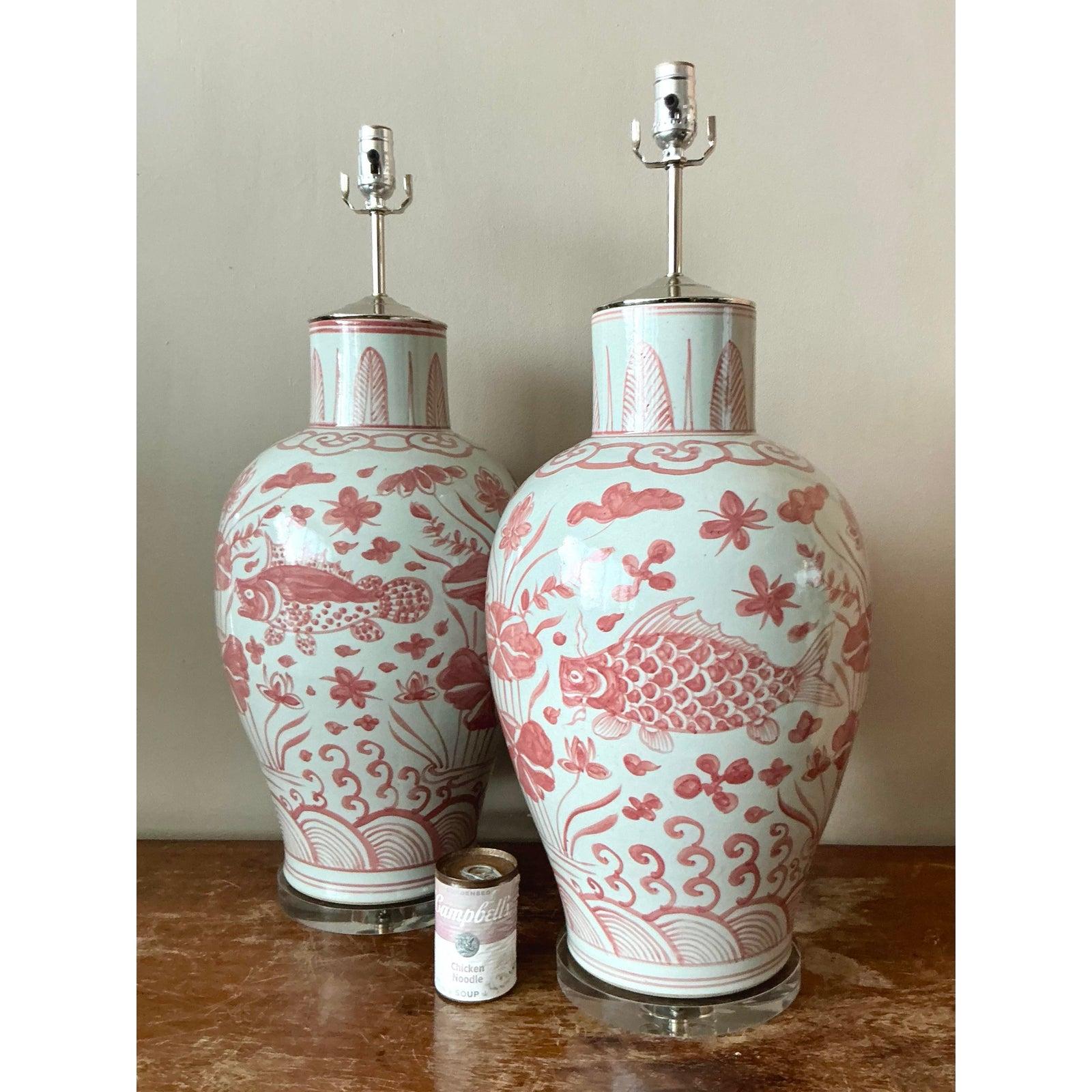 Elevate your interior with this captivating pair of vintage ceramic lamps, exuding a delightful Boho Chic aesthetic. Each lamp features an intricately glazed surface adorned with charming fish and floral motifs in a soothing palette of white and