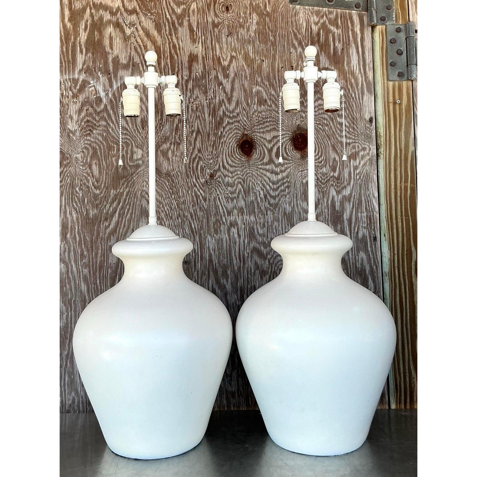 Elevate your space with this elegant pair of vintage boho glazed ceramic lamps. Featuring a softly sculpted, vase-like silhouette, these lamps boast a smooth glazed finish in a warm, neutral tone, effortlessly complementing coastal, bohemian, and