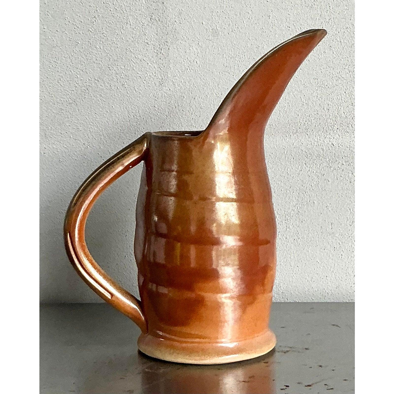 Discover this captivating vintage ceramic pitcher, a striking piece of artisan pottery by the acclaimed Peter Rose, embodying the free-spirited essence of Boho design from the mid-20th century. Crafted with an elongated, elegant spout and a