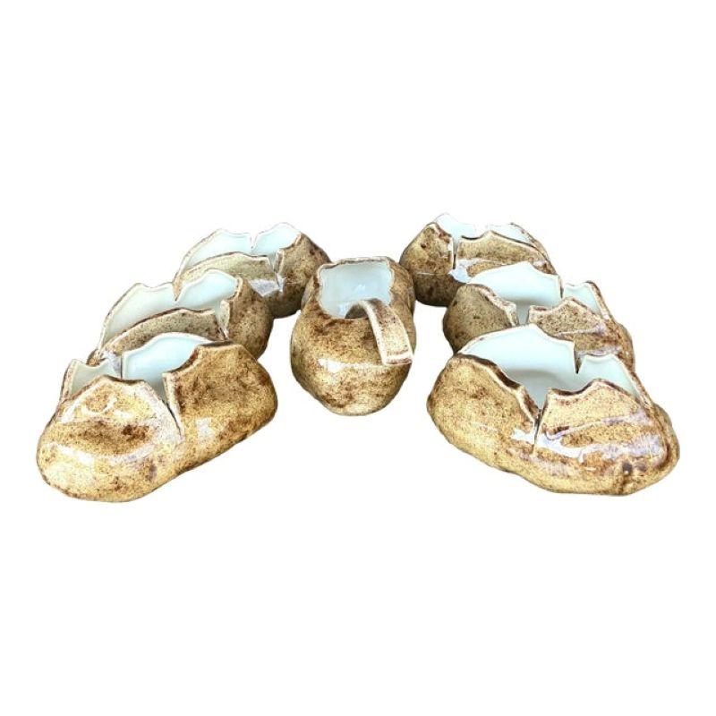 Serve up style with this charming Vintage Boho Glazed Ceramic Potato Serving Set of 8. Each piece features a beautifully glazed finish in warm, earthy tones, perfect for adding a touch of bohemian flair to your dining table. The unique design and