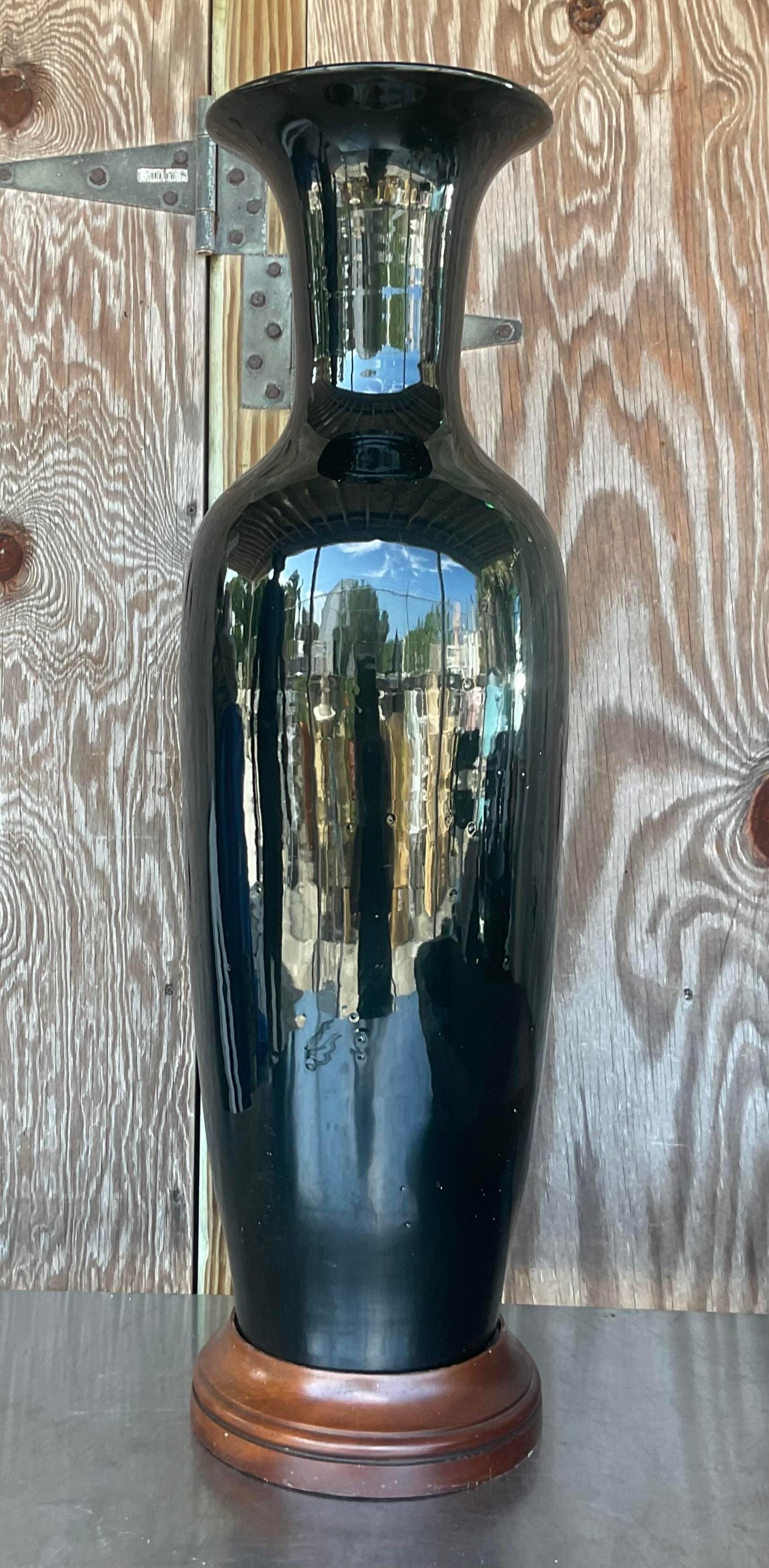 A fabulous vintage Boho Glazed ceramic vase. A classic Ming style in a black high gloss finish. Rests on a wooden plinth. Acquired from a Palm Beach estate. 