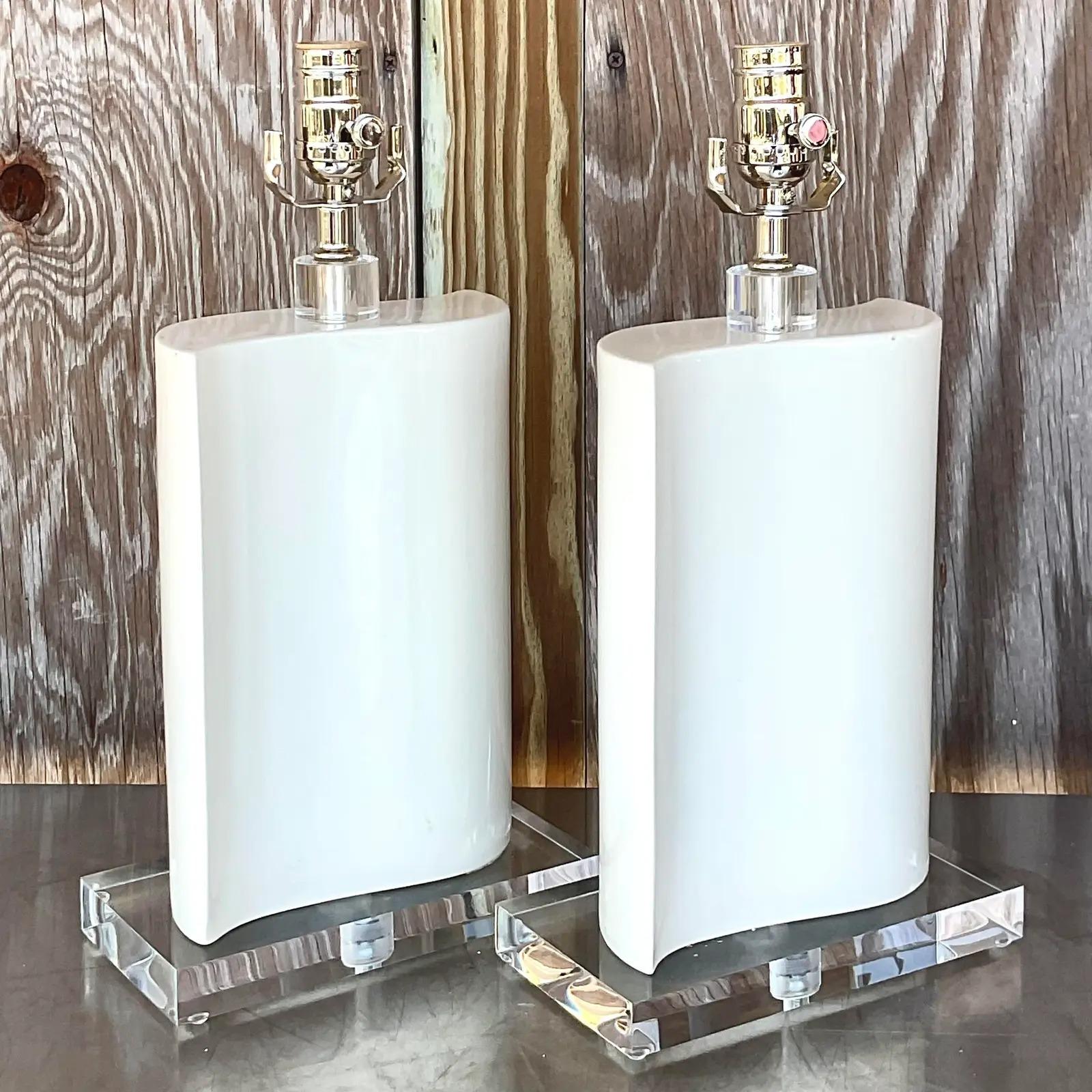 Fantastic pair of vintage glazed ceramic lamps. Beautiful wave design. All new wiring and hardware and brand new lucite plinths. Acquired from a Palm Beach estate.