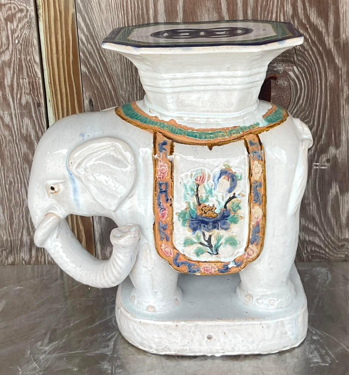 A fabulous vintage Boho low stool. A chic elephant with beautiful hand painted detail. A high gloss glazed ceramic finish. Perfect indoors or outside. You decide! Acquired from a Palm Beach estate.
