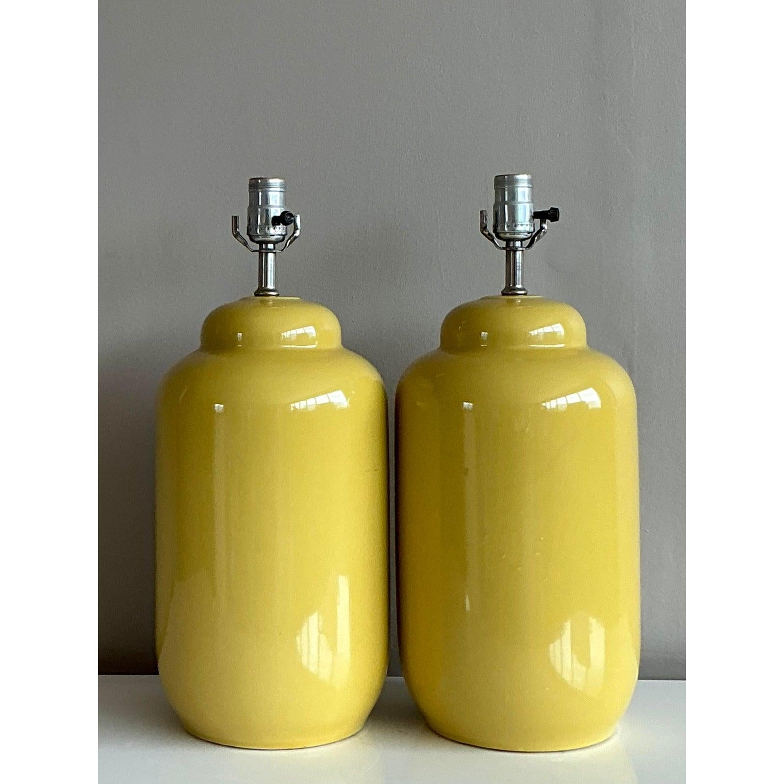 Inject a brilliant pop of sunshine into your interior with this stunning pair of vintage ceramic lamps. Featuring a classic ginger jar silhouette, these lamps are finished in a vibrant and cheerful yellow high-gloss glaze that instantly energizes