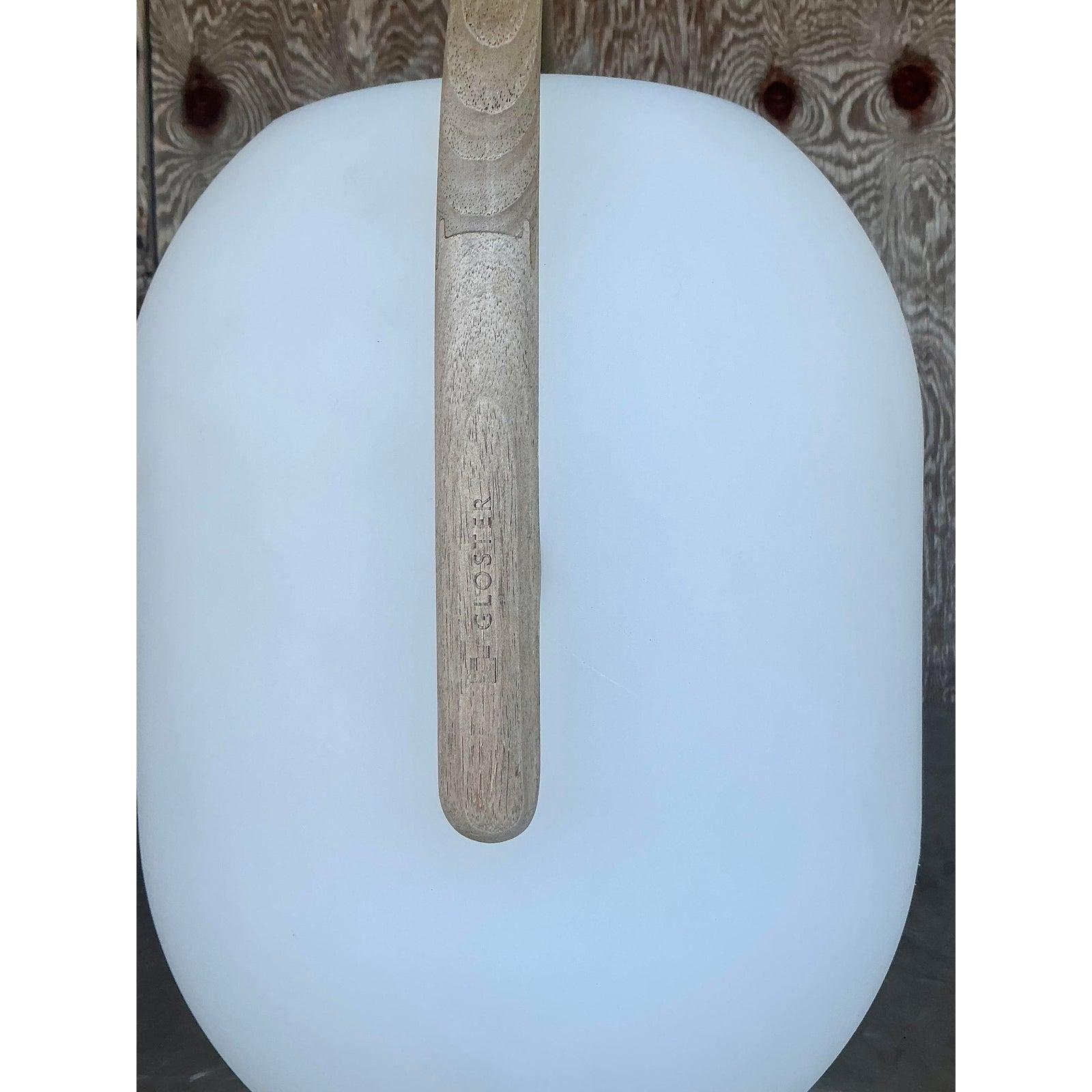 Illuminate your outdoor sanctuary with this stunning vintage Gloster Ambient Solar Lantern, where bohemian style meets modern innovation. Crafted with a matte white sculptural body and topped with a natural teak handle, this solar-powered lantern is