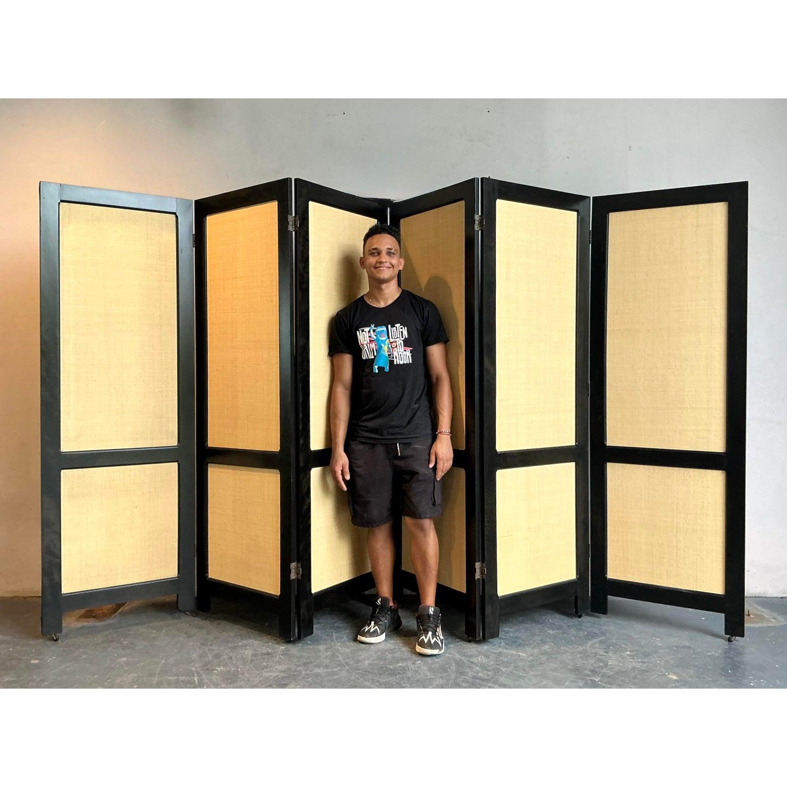 This exquisite vintage folding screen embodies a timeless elegance, reminiscent of Ralph Lauren's iconic design sensibilities. Crafted with rich dark wood frames and natural grass cloth panels, it exudes a sophisticated yet relaxed 