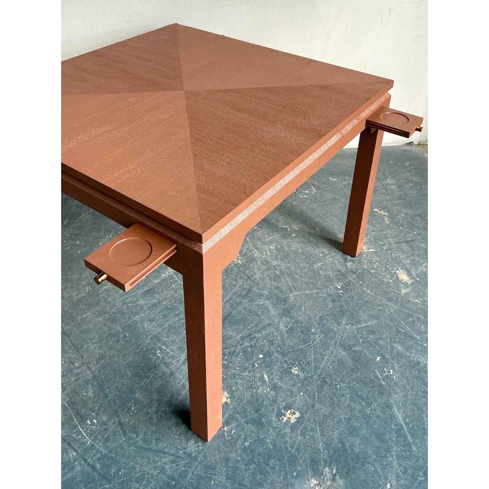 This distinctive vintage table channels the clean architectural forms of Mid-Century design, elevated by a sophisticated and unusual material finish. The entire surface and frame are wrapped in a textured linen or coarse grasscloth, finished in a