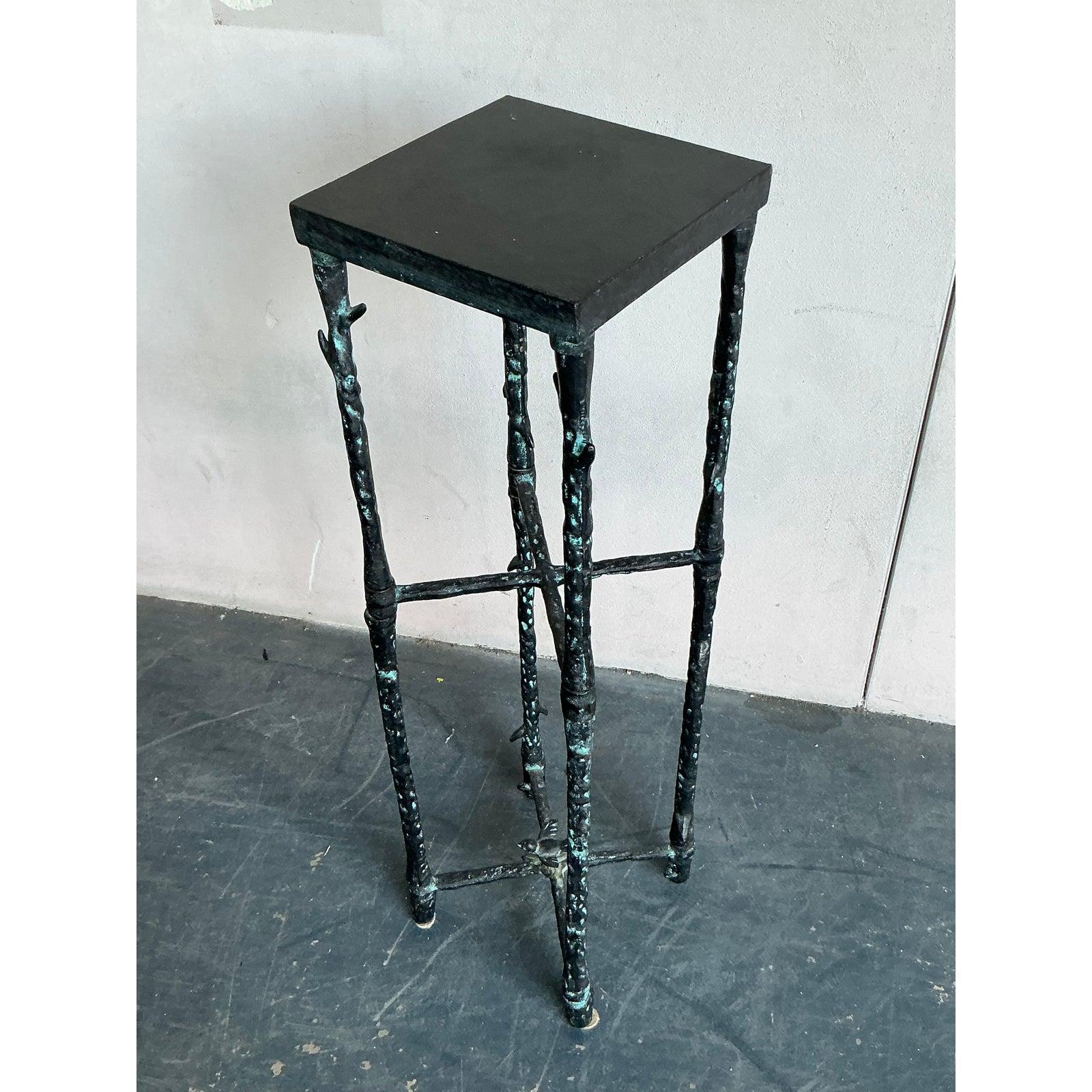 This exceptional vintage side table is a high-style piece, featuring a highly textured metal frame meticulously cast and finished to resemble gnarled, weathered bamboo. This trompe l'oeil design offers an organic yet sophisticated form, contrasting