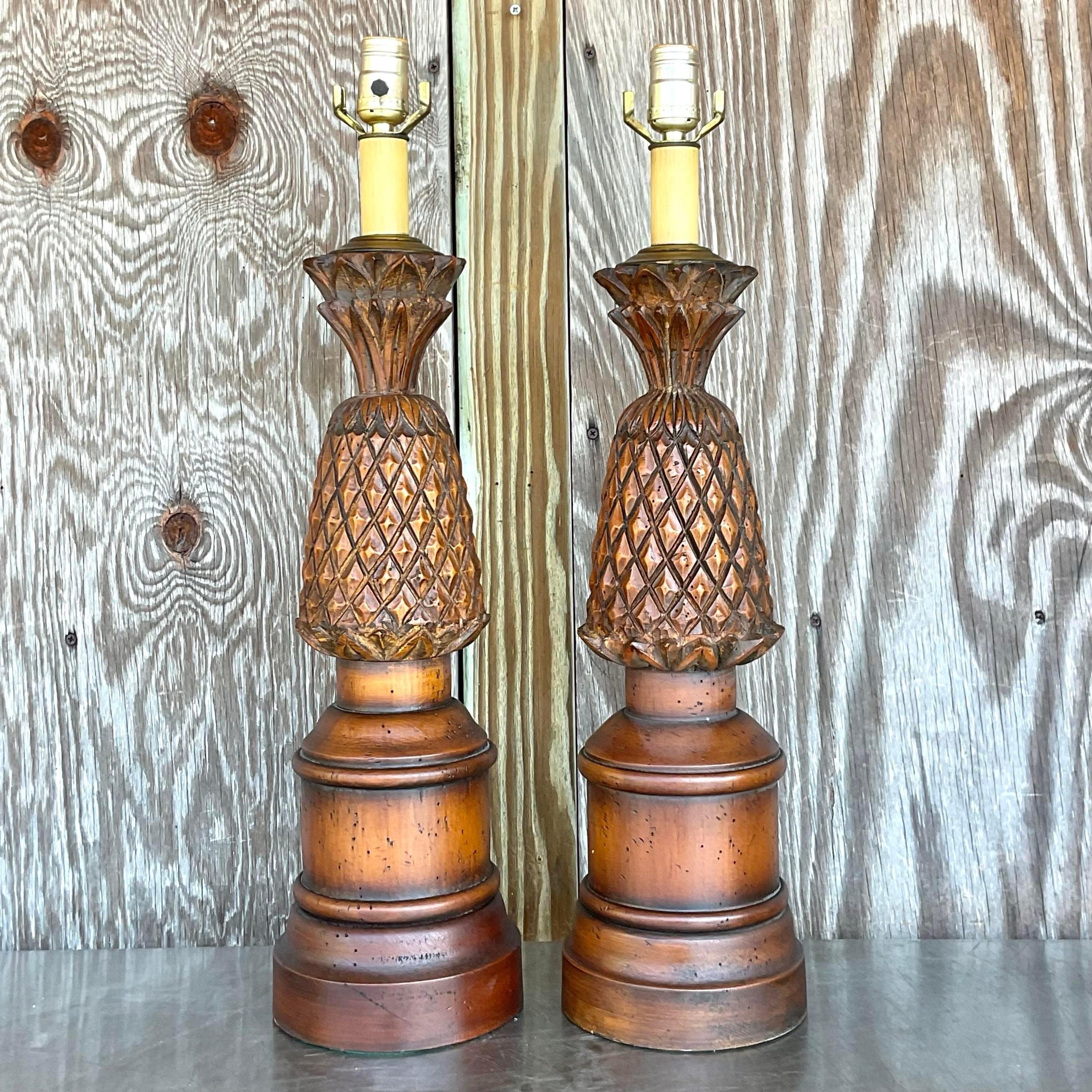 Add a touch of bohemian charm to your space with this delightful pair of Vintage Boho Hand Carved Pineapple Lamps. Crafted with intricate detailing and warm, natural wood, these lamps embody the whimsical spirit of American boho style, bringing a