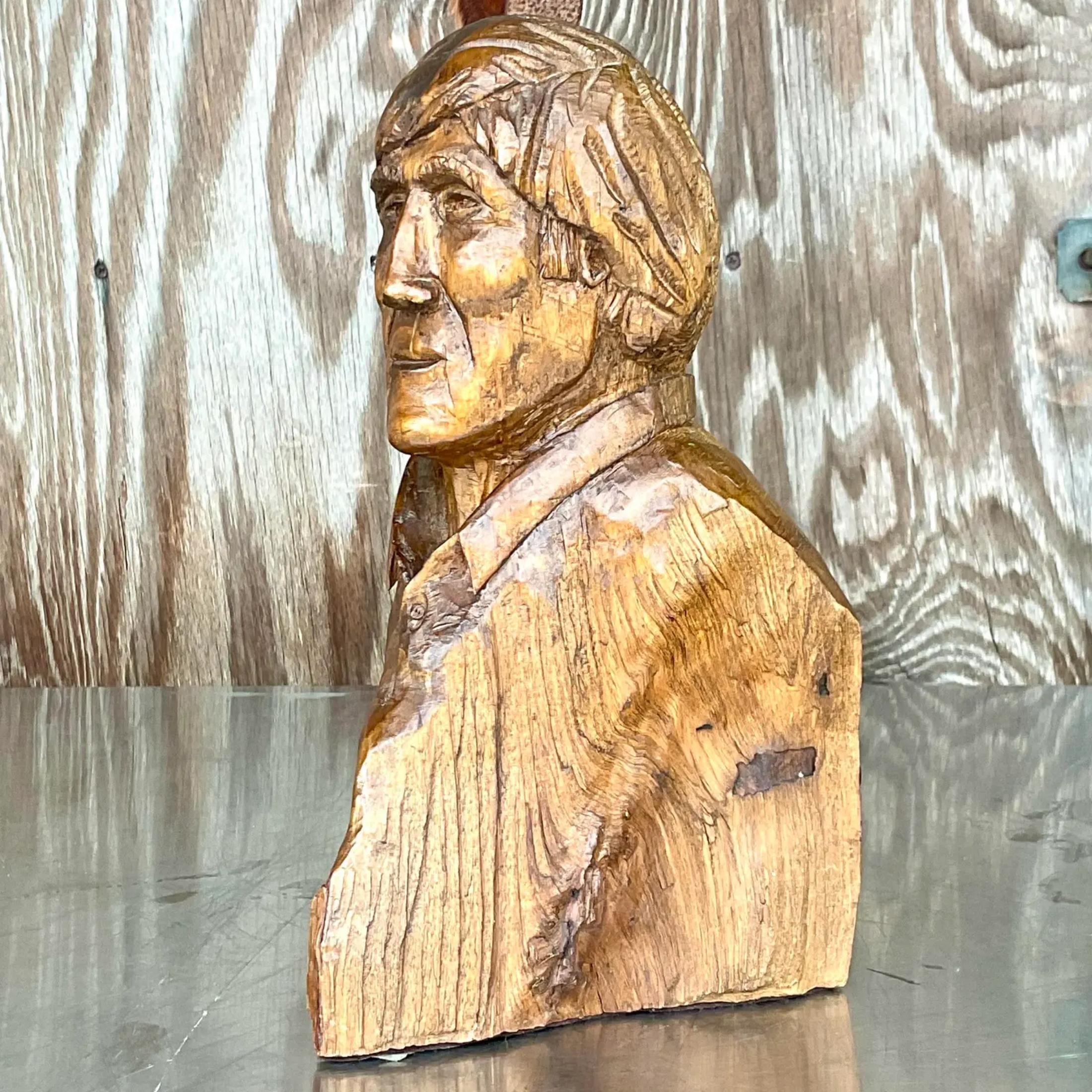 Vintage Boho sculpture of man. Hand carved with beautiful wood grain detail. Done by the artist Michael S. Wilson. Acquired from a Palm Beach estate. 