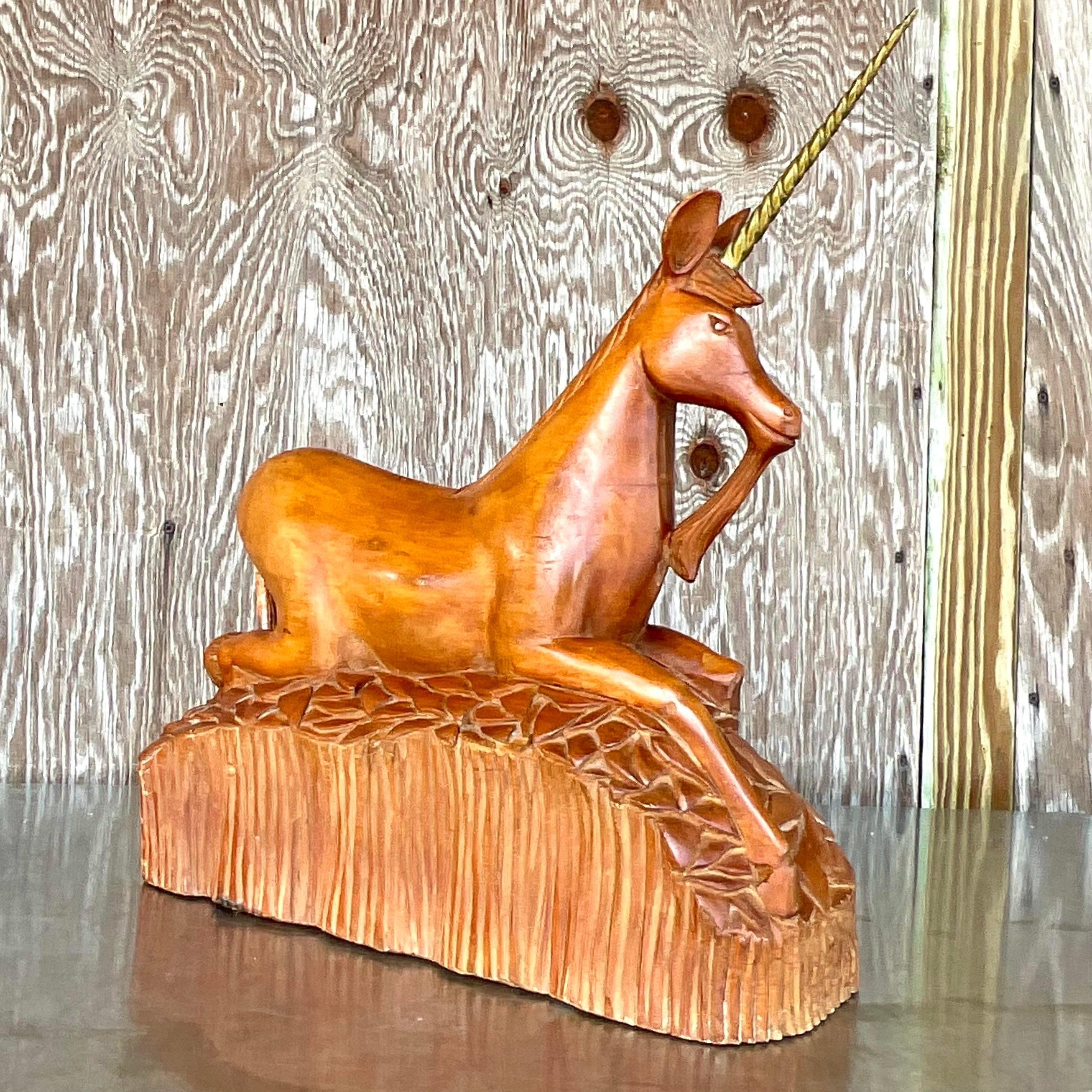 A fantastic vintage Boho unicorn. Chic hand carved wood with a twisted brass horn. Acquired from a Palm Beach estate.