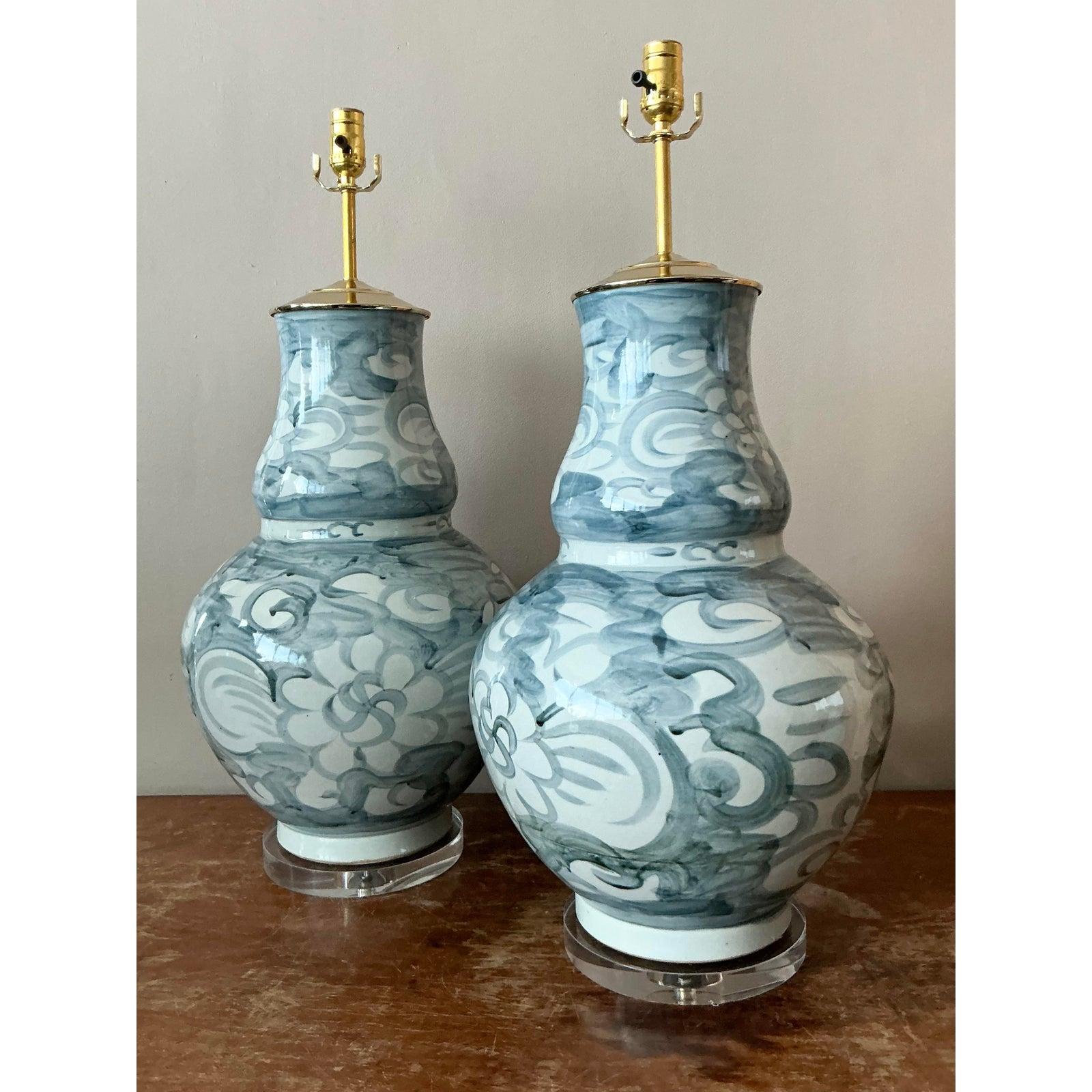 Elevate your interior with this captivating pair of vintage ceramic urn lamps, masterfully hand-painted with an enchanting blue and white motif. These lamps exude a distinct Boho Chic elegance, featuring organic, free-flowing patterns that evoke a