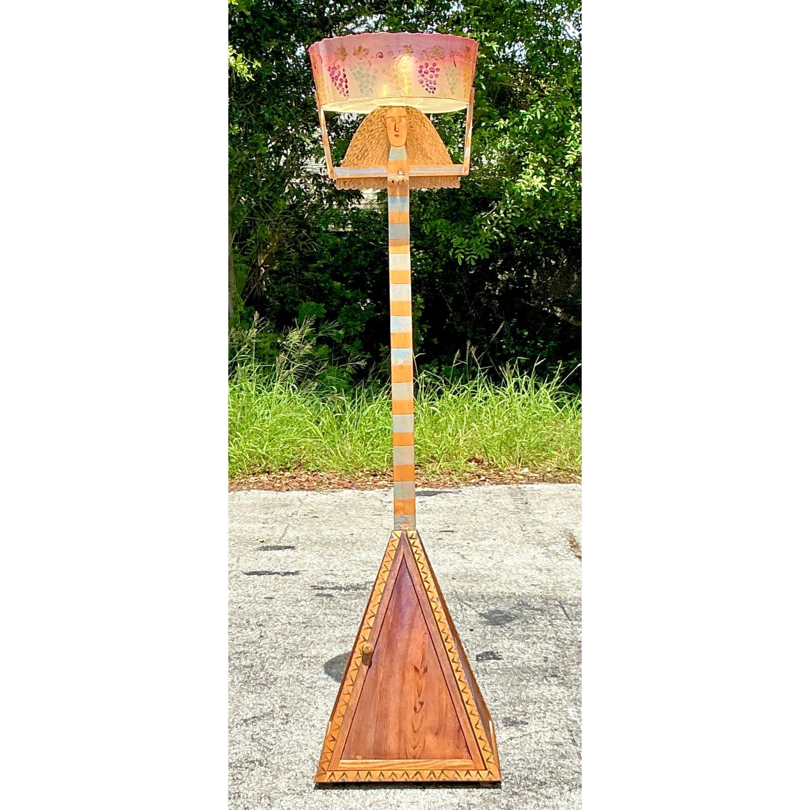 A spectacular and truly one-of-a-kind piece of functional sculpture, this vintage floor lamp is a testament to artistic vision and playful design. Drawing inspiration from Folk Art and the Postmodern movement, this towering lamp is built around a