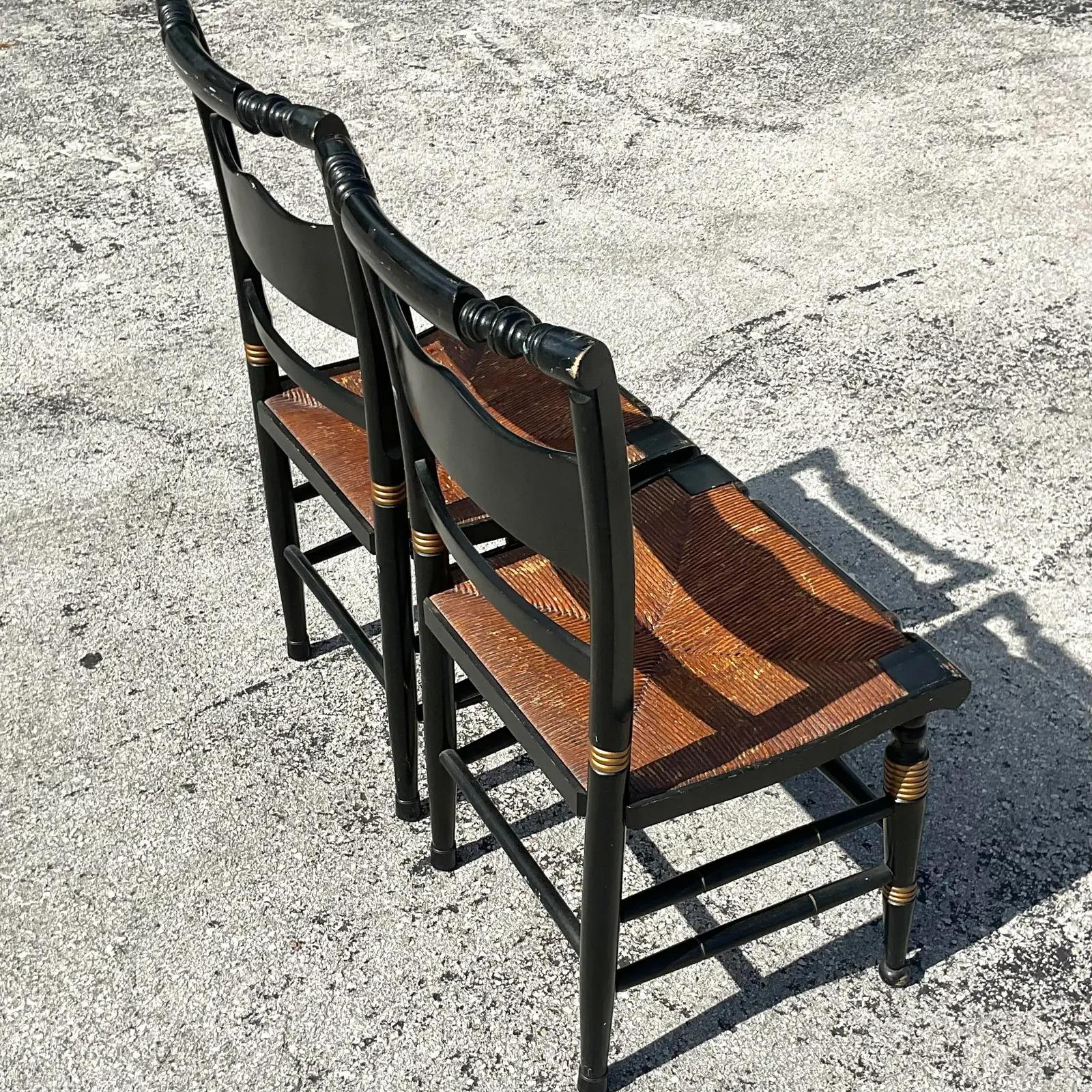 A fantastic pair of vintage Boho dining chairs. Thr iconic Hitchcock style with beautiful hand painted detail. Vintage rush seats with beautiful patina. Acquired from a Palm Beach estate.