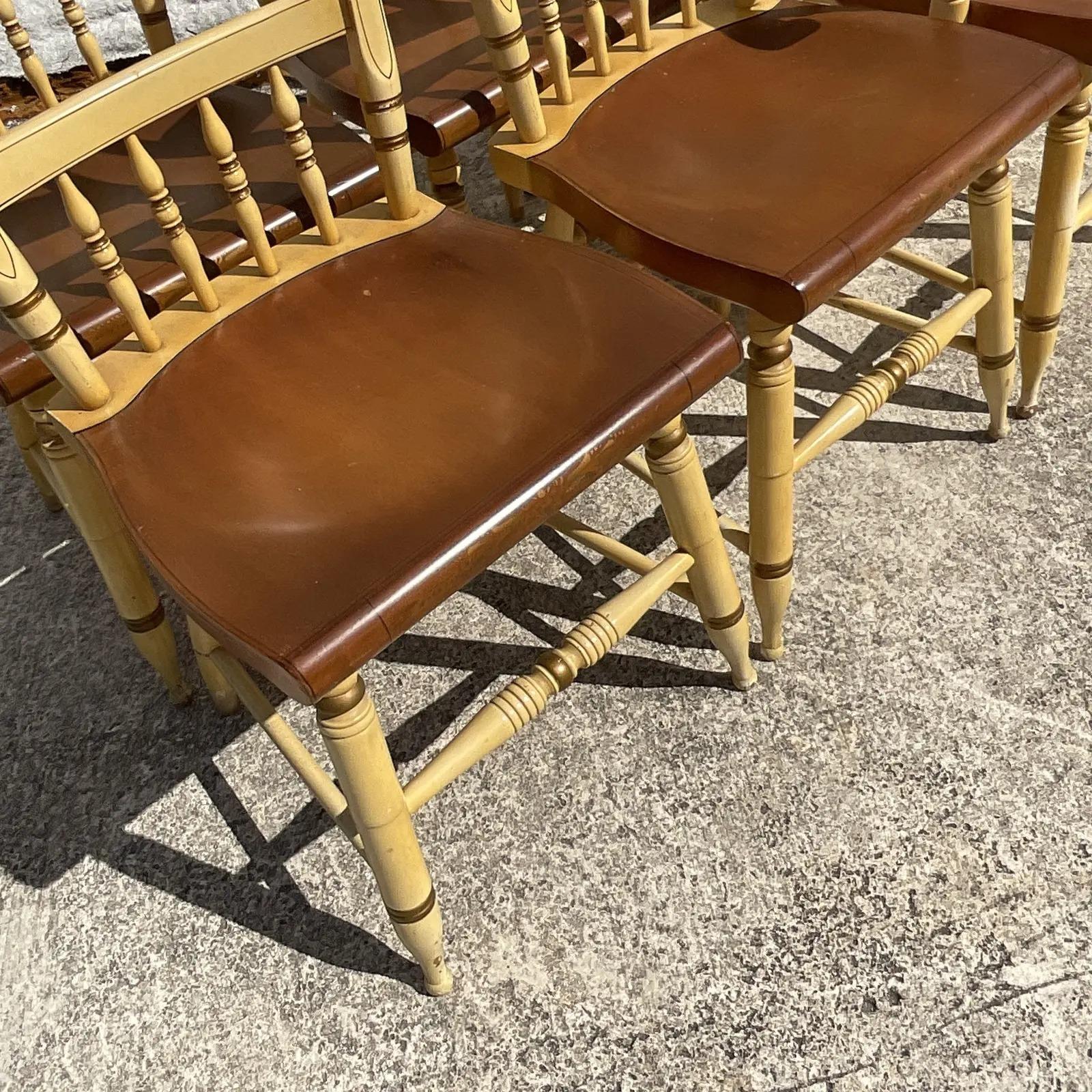 Fantastic set of six vintage Boho dining chairs. The iconic Hitchcock design with the signature signature along the back. Hand painted classic gilt details. Acquired from a Palm Beach estate.

Arm chair is 22.5 wide and one inch lower than the