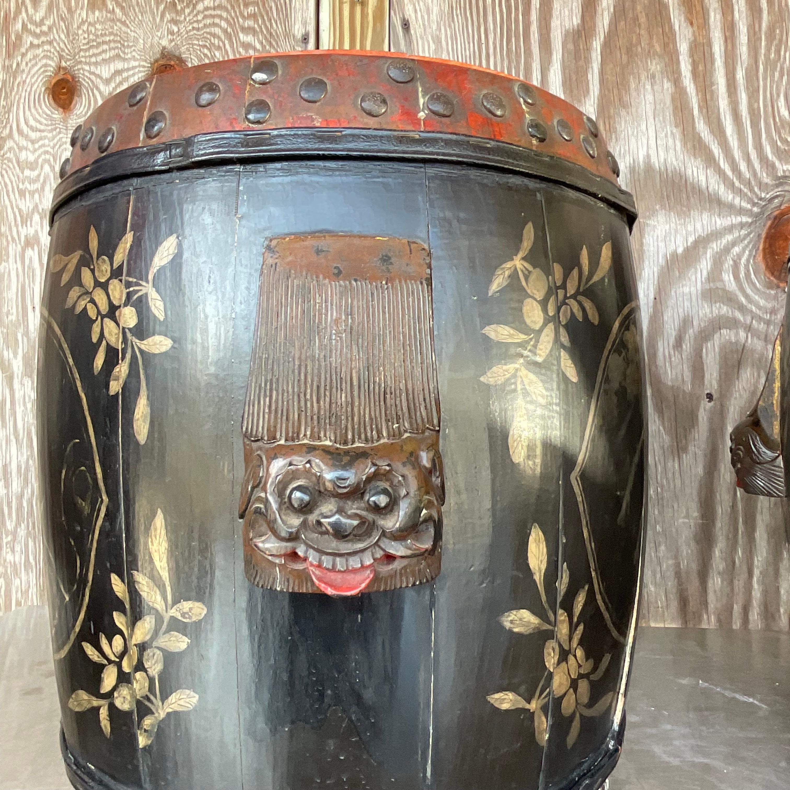 Elevate your space with these vintage boho hand-painted lidded drums, a harmonious fusion of American craftsmanship and artistic expression. Each drum showcases intricate hand-painted designs, echoing the vibrant spirit of American culture and