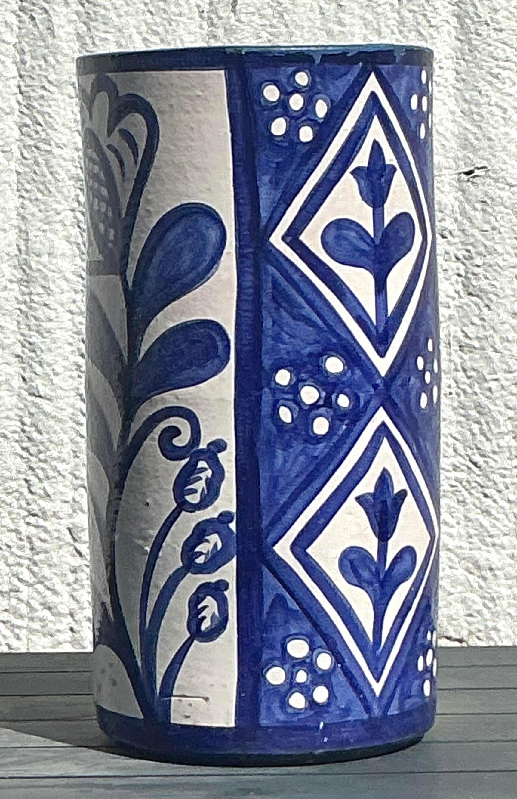 Add a splash of color and charm to your entryway with this Vintage Boho Hand-Painted Umbrella Stand. Featuring intricate, hand-painted designs in vibrant hues, this stand combines functionality with bohemian flair. Its tall, slender form is perfect