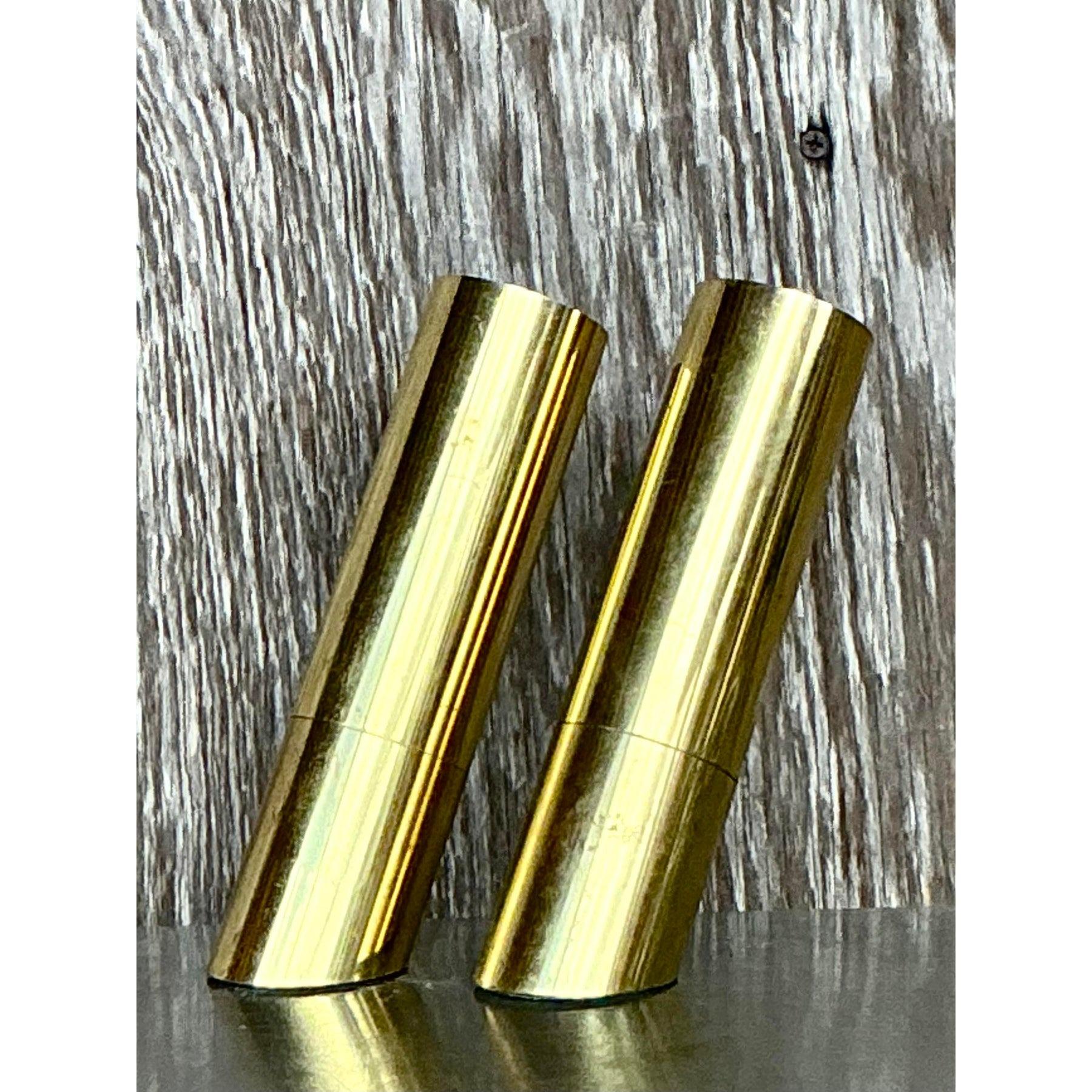 Elevate your space with this striking pair of vintage Heyco brass spotlight lamps. Featuring a sleek cylindrical design with a luxurious polished brass finish, these compact yet impactful lamps offer a modernist aesthetic that seamlessly complements