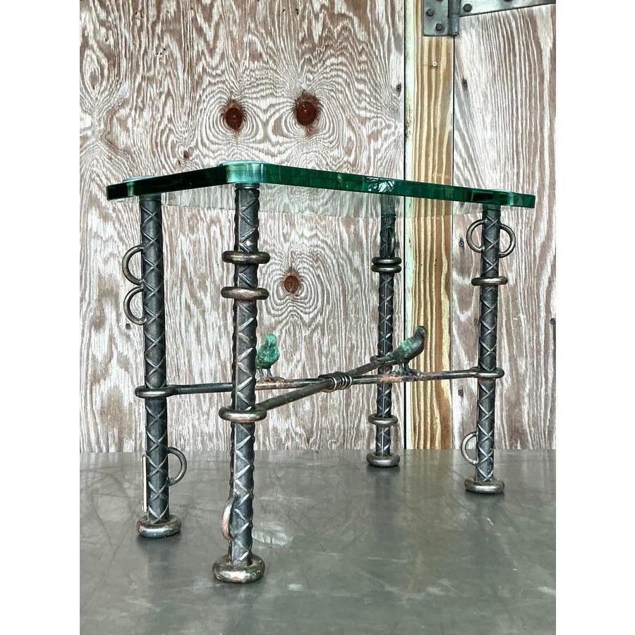 Stunning vintage Ilana Goor side table crafted from rebar with intricate sculpted bird accents. This rare statement piece embodies a perfect fusion of industrial strength and boho artistry. With its bold design and expert craftsmanship, it’s both