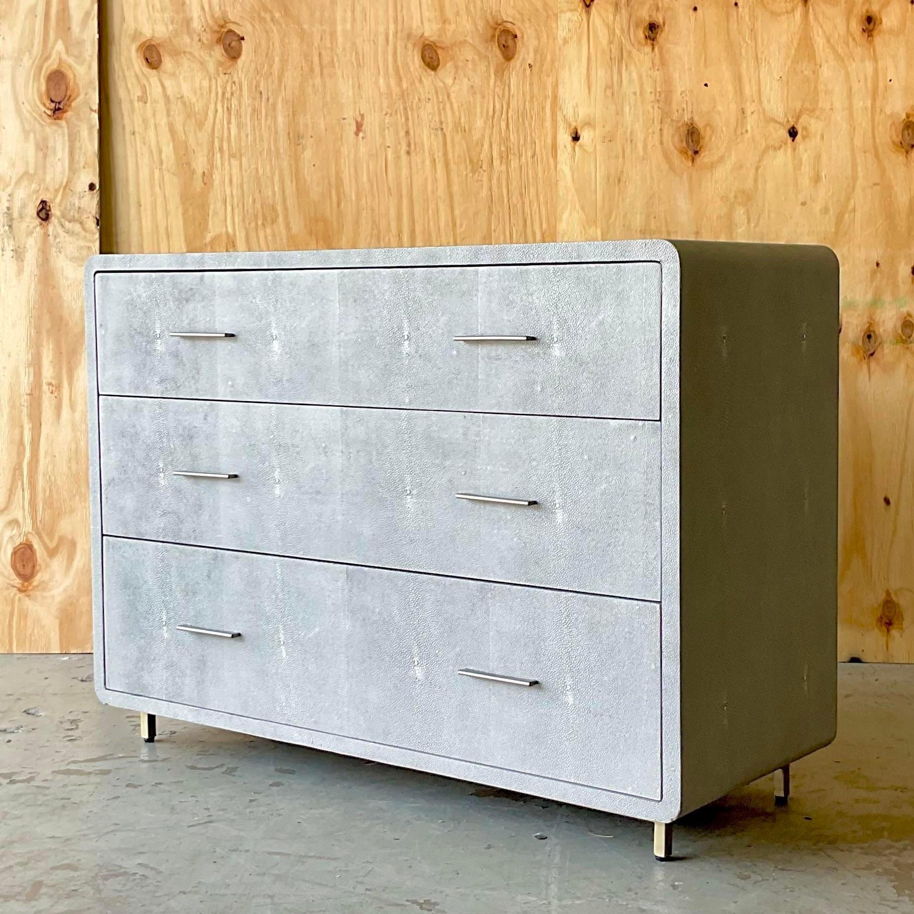 A fantastic vintage Contemporary chest of drawers. Made by the Interlude group and marked inside in the top drawer. A beautiful faux Shagreen wrapped cabinet with brushed chrome pulls. Two chests available if a pair is needed. Acquired from a Palm