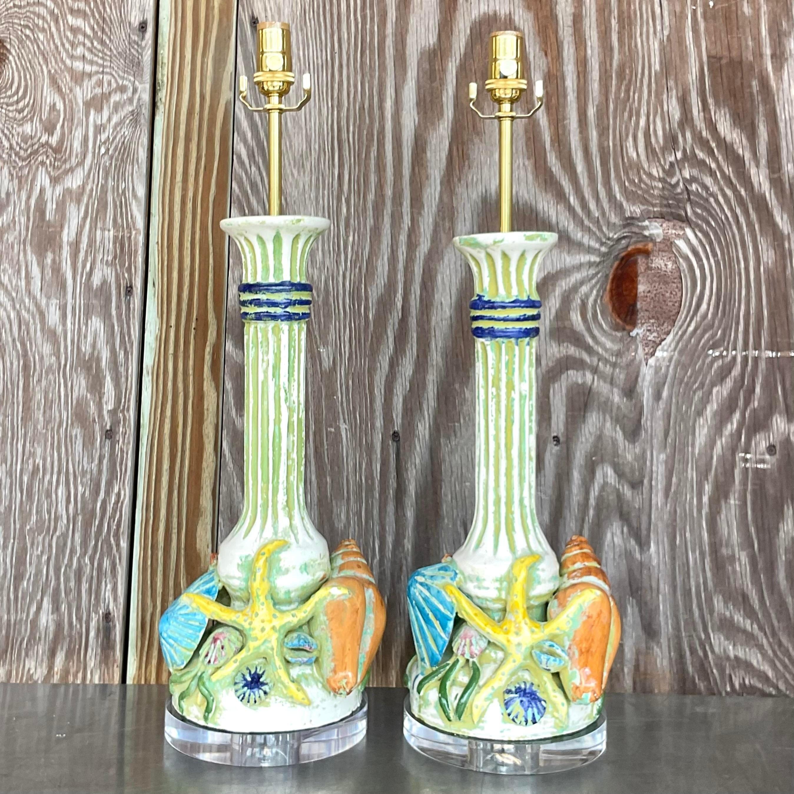 Capture the essence of seaside charm with this exquisite pair of Vintage Boho Italian Hand Painted Shells Lamps. Each lamp exudes coastal elegance, adorned with delicate hand-painted shells that evoke memories of sun-soaked shores and tranquil ocean