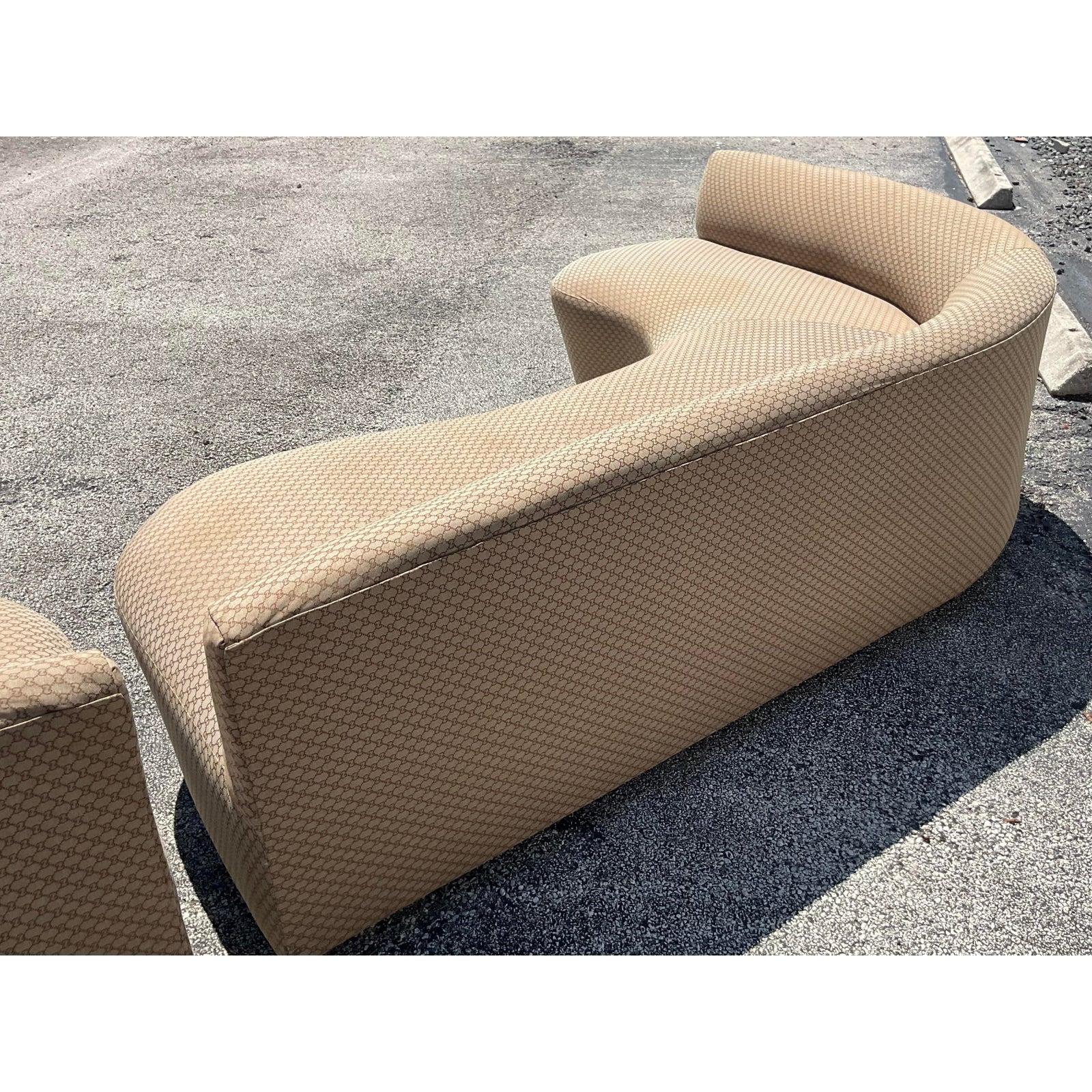 An exceptional pair of vintage Boho sofa. Custom built in a chic biomorphic shape. Great together but also work beautifully apart. Covered in a logo jacquard. The sofas come from a mansion owned by a big celebrity that was sold to an even bigger